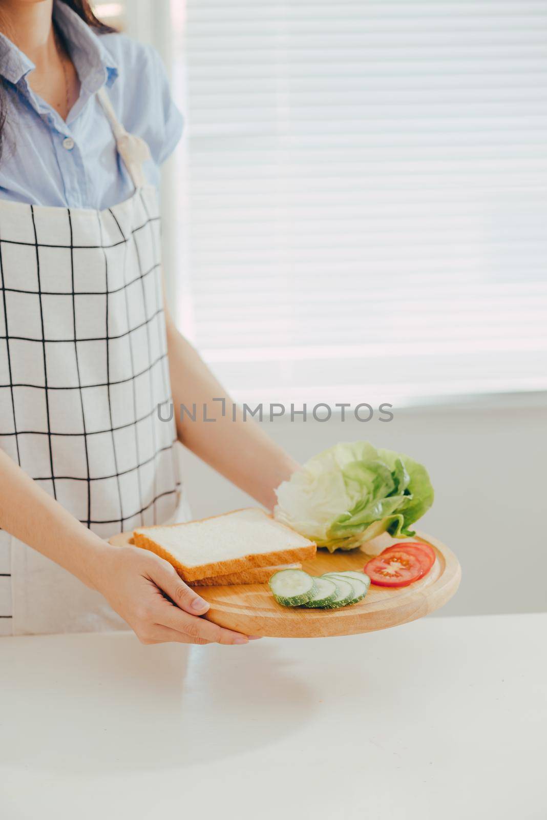 Woman apron preparing a breakfast in the kitchen