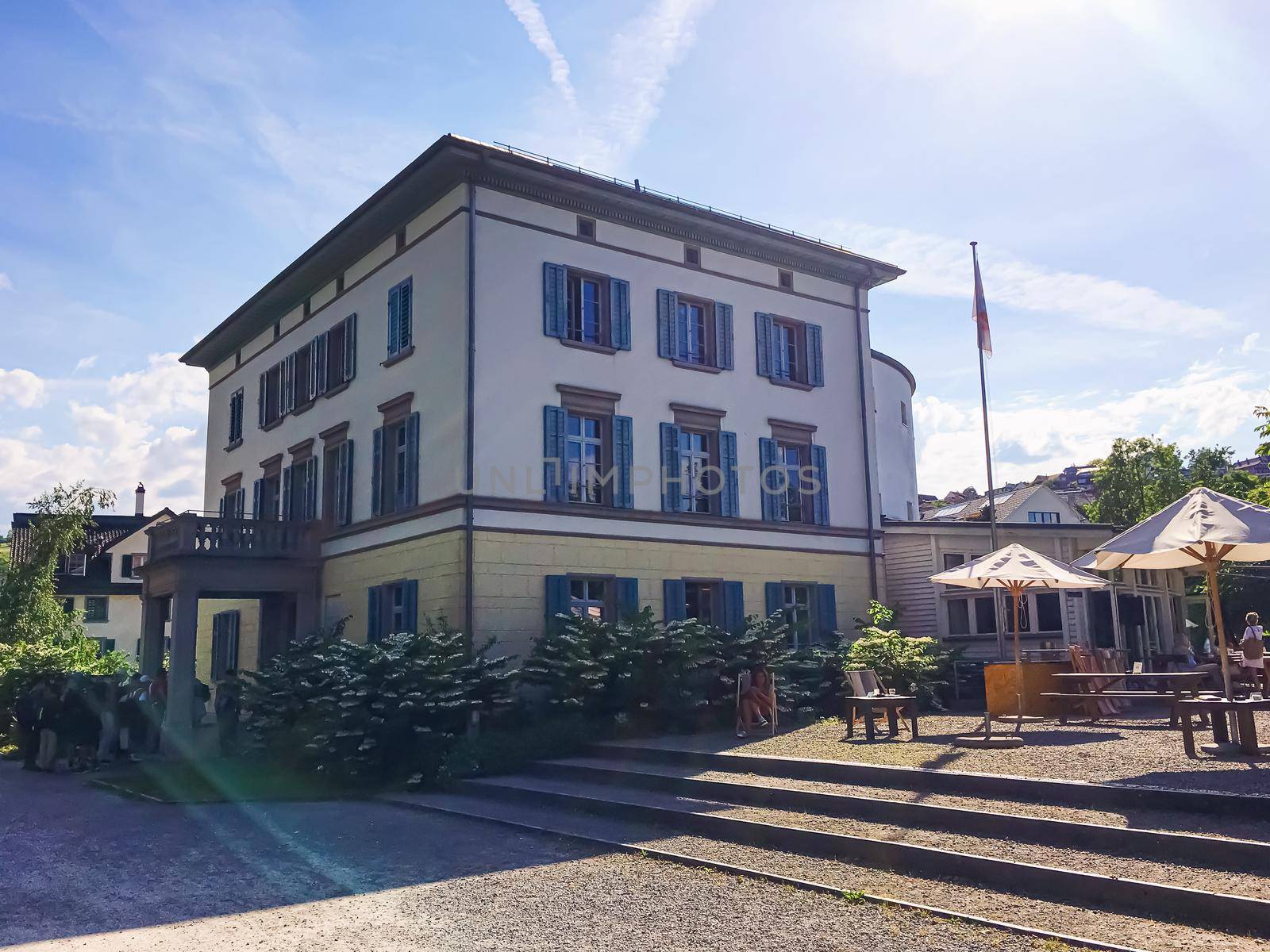 Richterswil, canton of Zurich, Switzerland circa June 2021: Restaurant and house on street, Swiss architecture and real estate