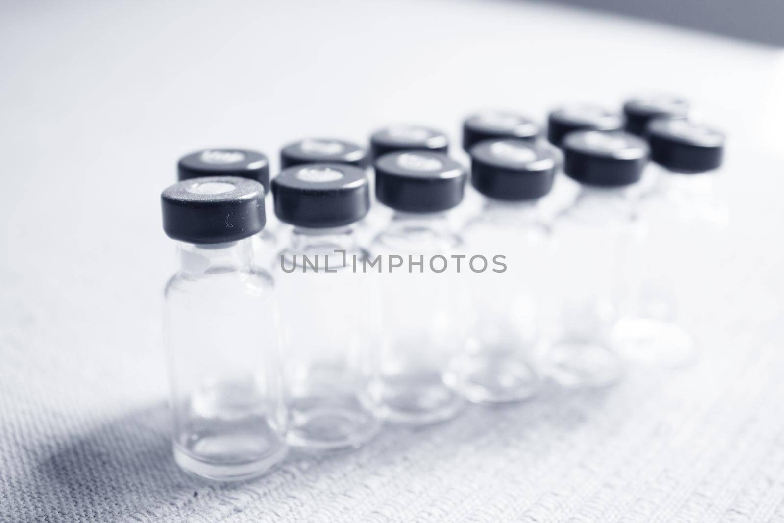 Empty glass jars of coronavirus vaccines. No people