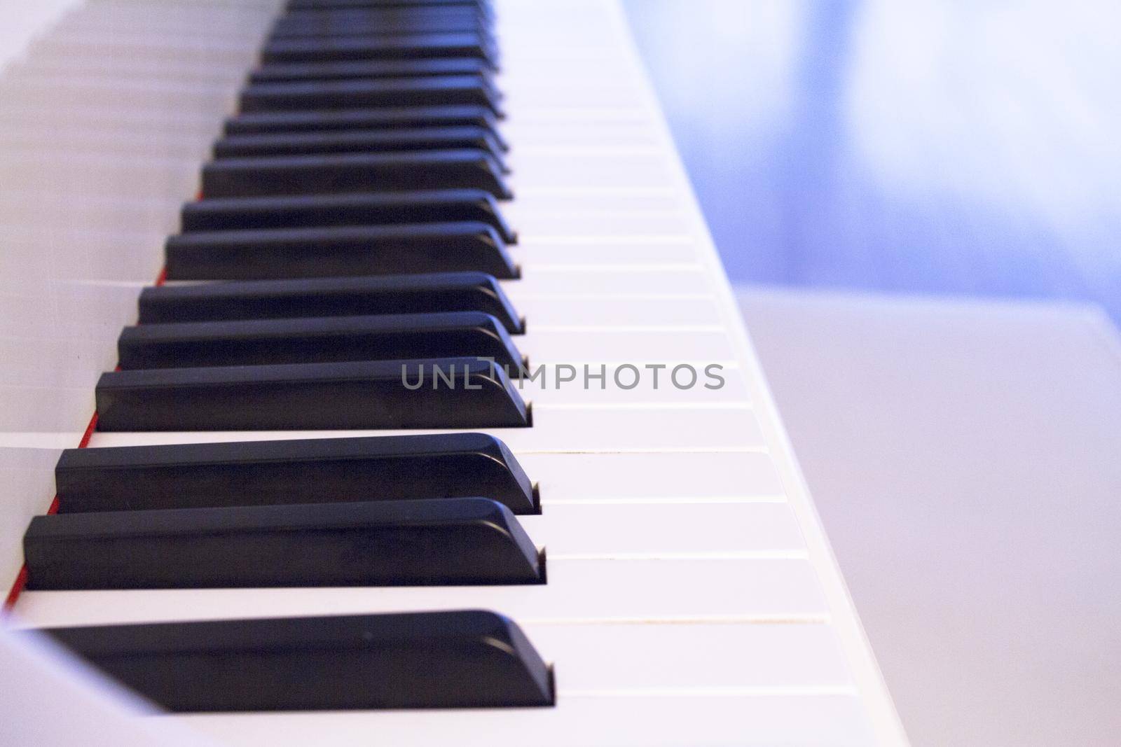 Part of the keyboard of a piano in white color by GemaIbarra