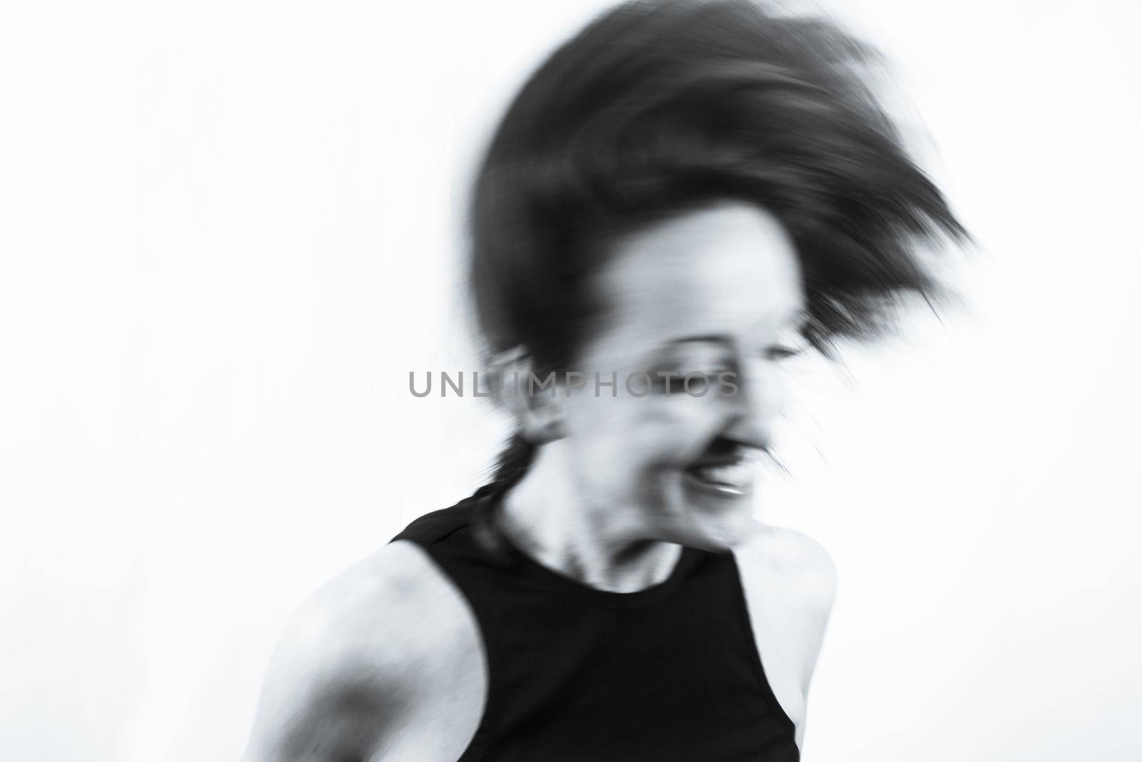 Motion blur portrait of woman over 40. Black tshirt