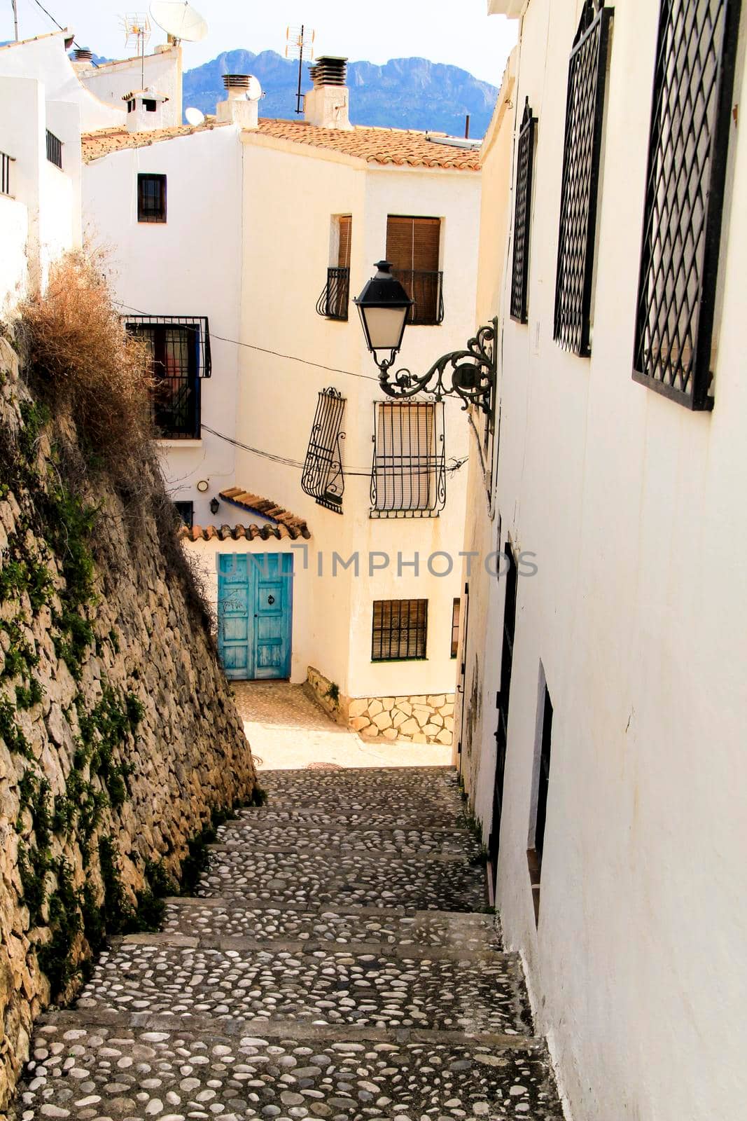 Narrow streets and beautiful whitewashed facades in Altea village, Alicante, Spain