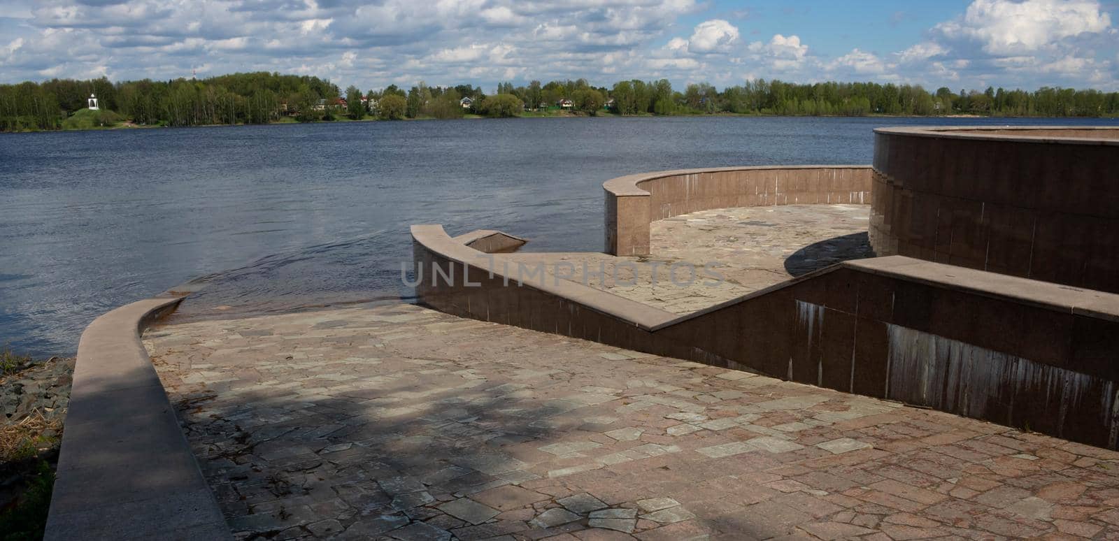 The spring river flooded the embankment, steps and descent.