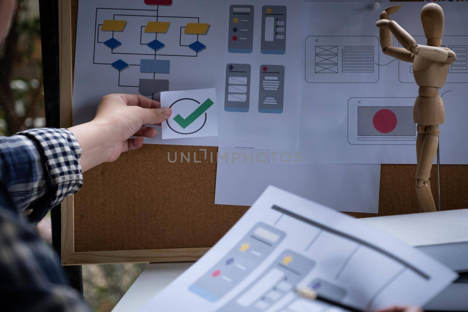 A close-up of an ux ui developer and an ui designer working on a mockup icon interface for a mobile app