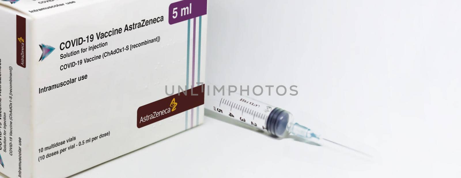 Cambridge, UK, february 5th 2021: A syringe next to the AstraZeneca Covid-19 Vaxzevria vaccine box by rarrarorro