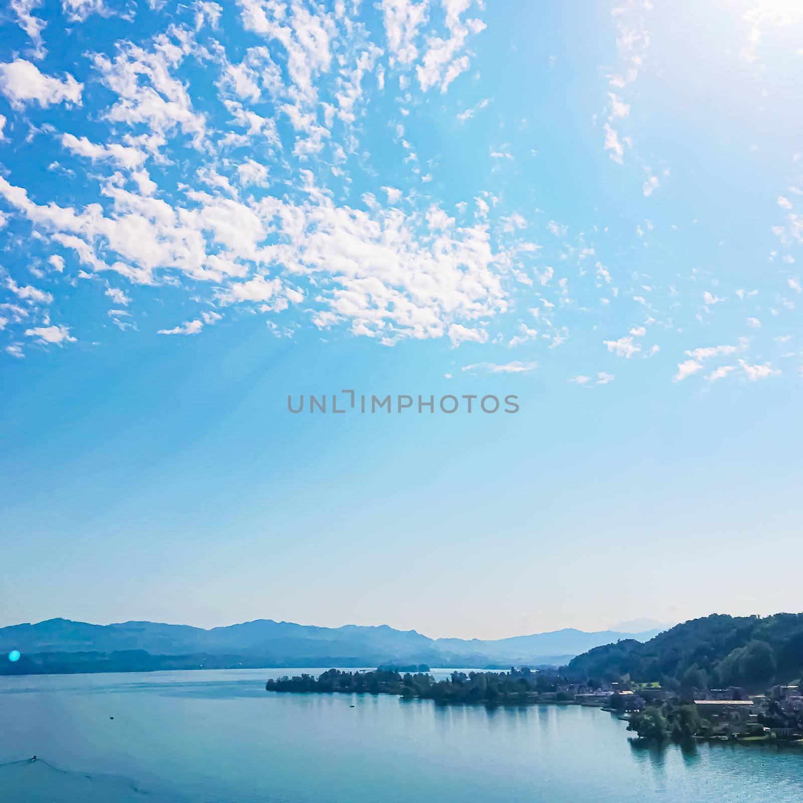 Idyllic Swiss landscape, view of lake Zurich in Wollerau, canton of Schwyz in Switzerland, Zurichsee, mountains, blue water, sky as summer nature and travel destination, ideal as scenic art print.