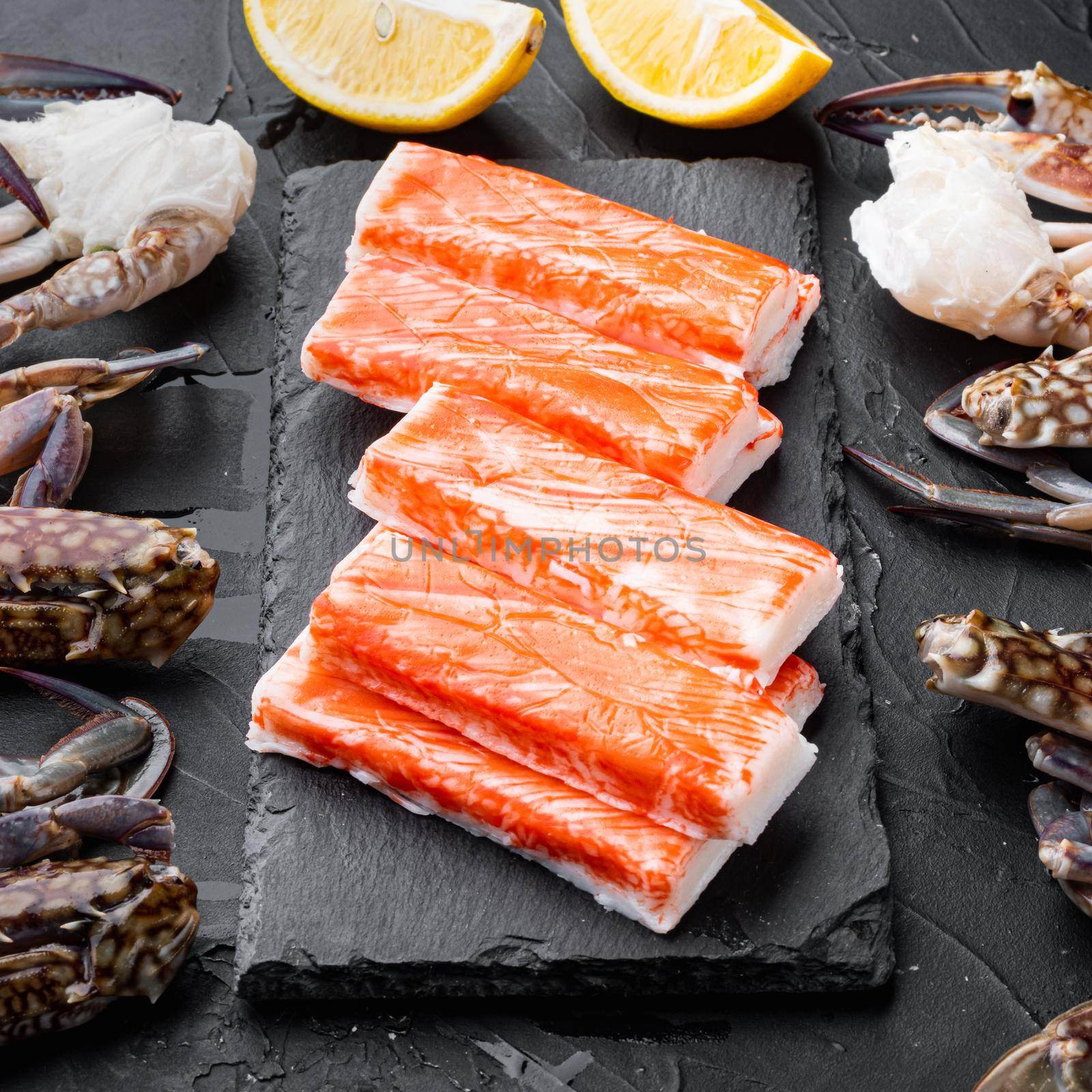 Fresh Crab meat surimi with blue swimming crab set, on stone board, on black background