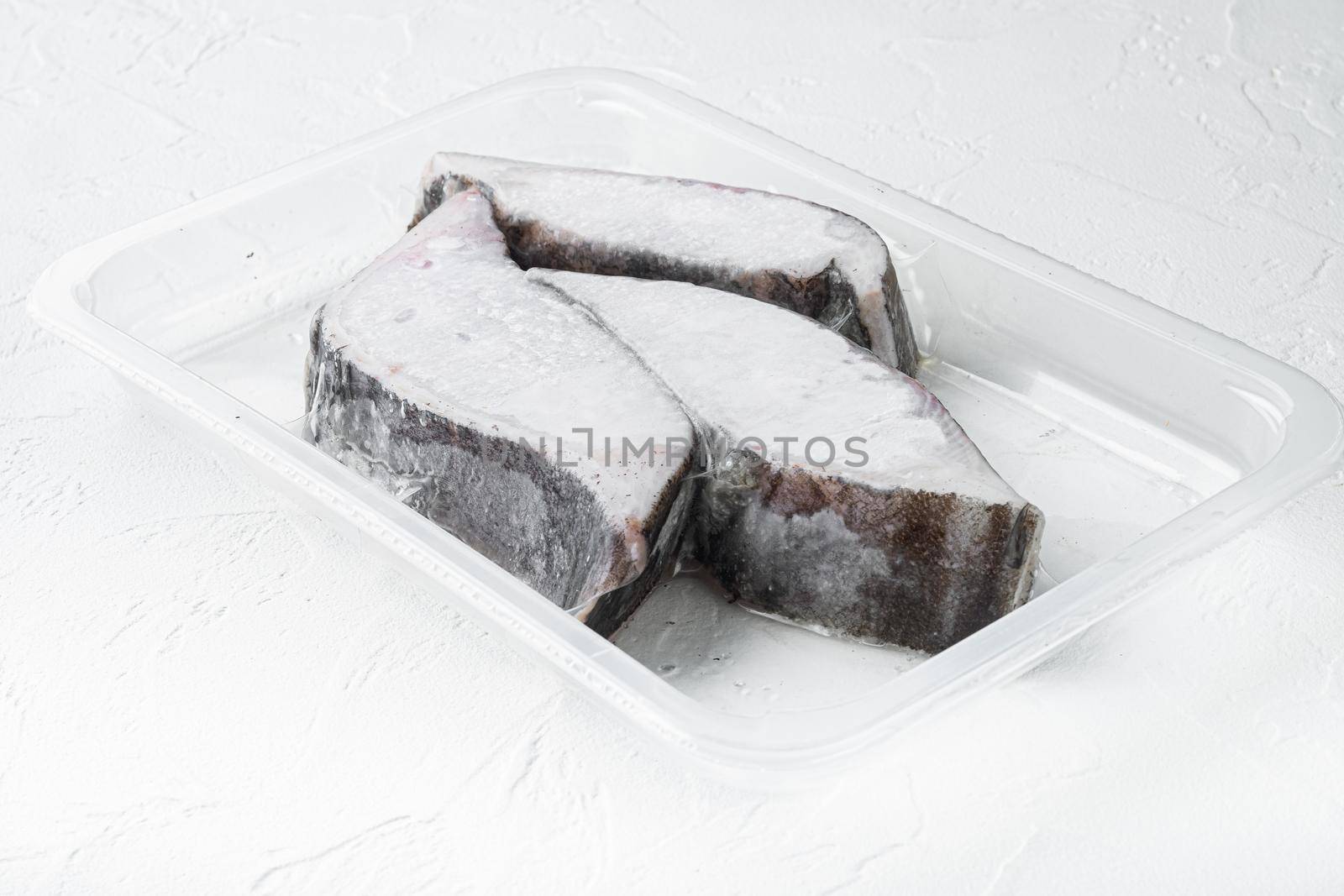 Raw fillets frozen halibut airtight vacuum pack set, on white stone table background