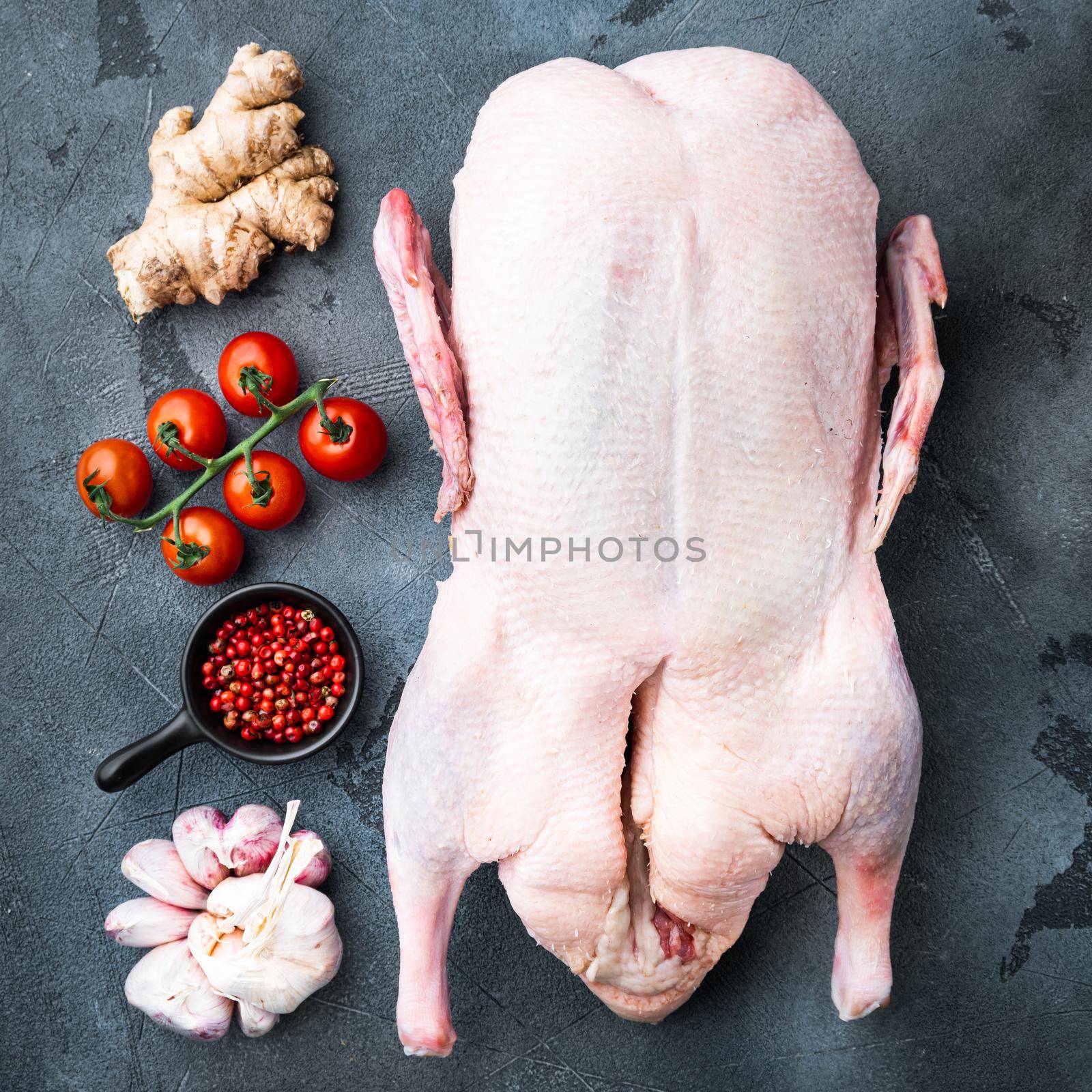 Whole raw duck meat on grey background, top view.