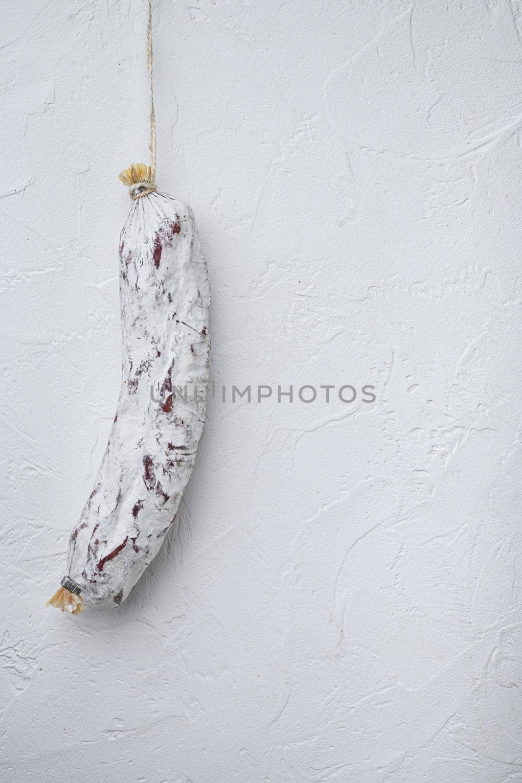 Sausage salchichon on white background with space for text.