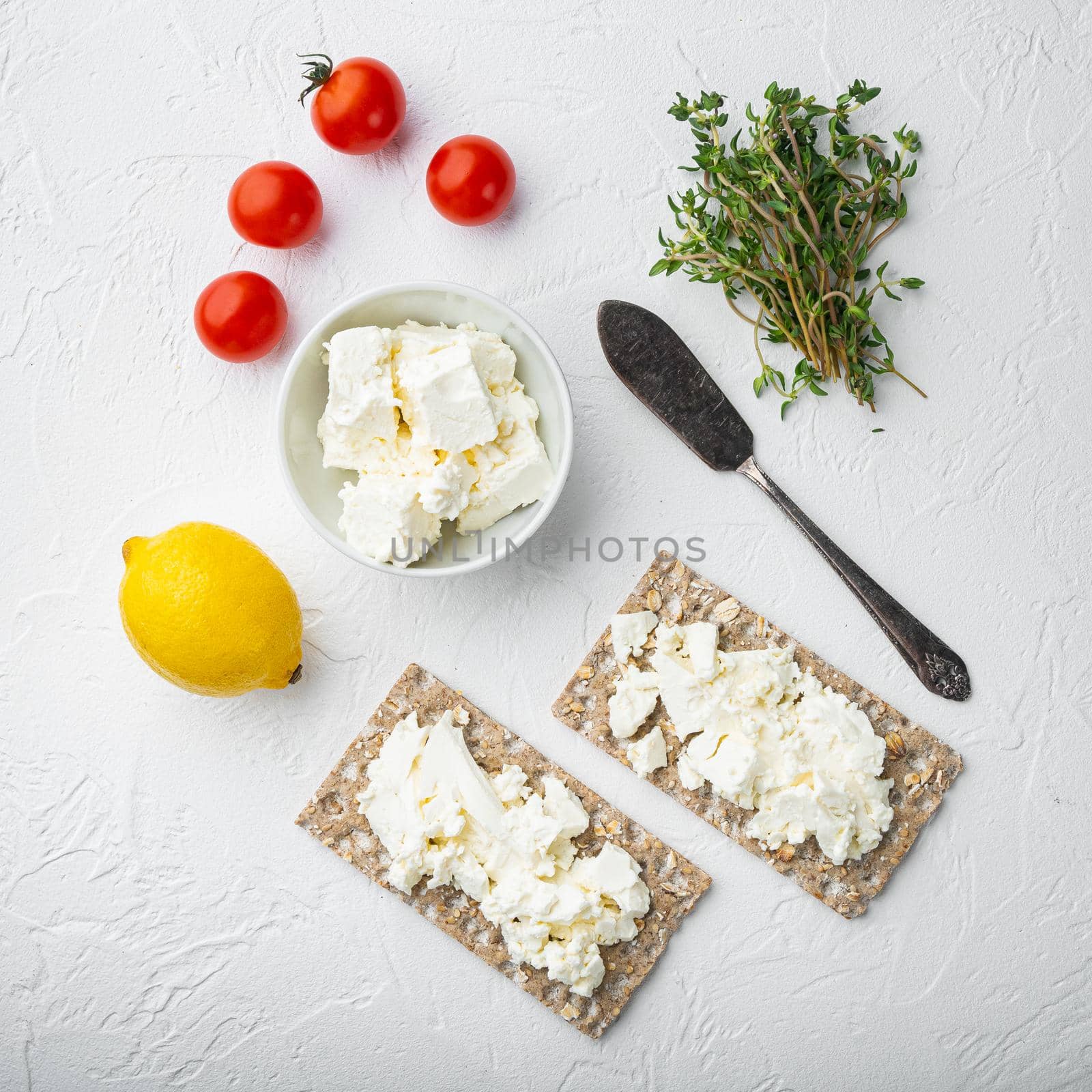 Crispbread sandwich, square format, on white stone table background, top view flat lay by Ilianesolenyi