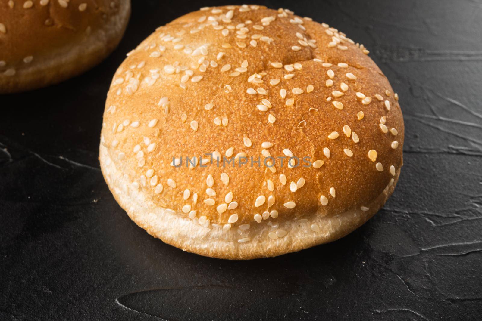 Sandwich bun with sesame seeds set, on black stone background