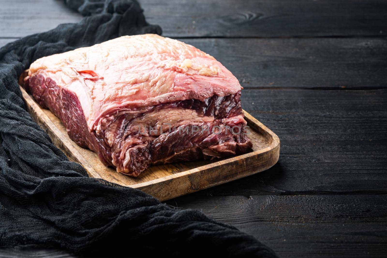 Top sirloin beef steaks cut, on black wooden table, on black wooden table