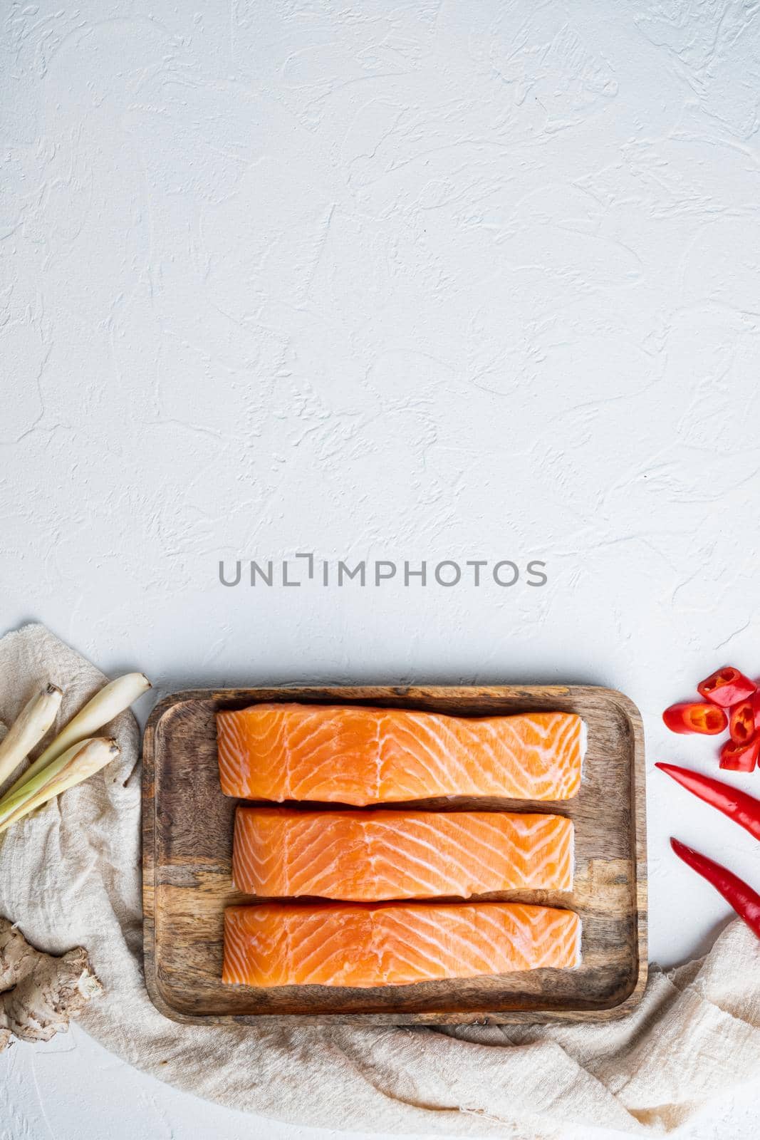 Raw trout with herb, on white textured background, flat lay with space for text