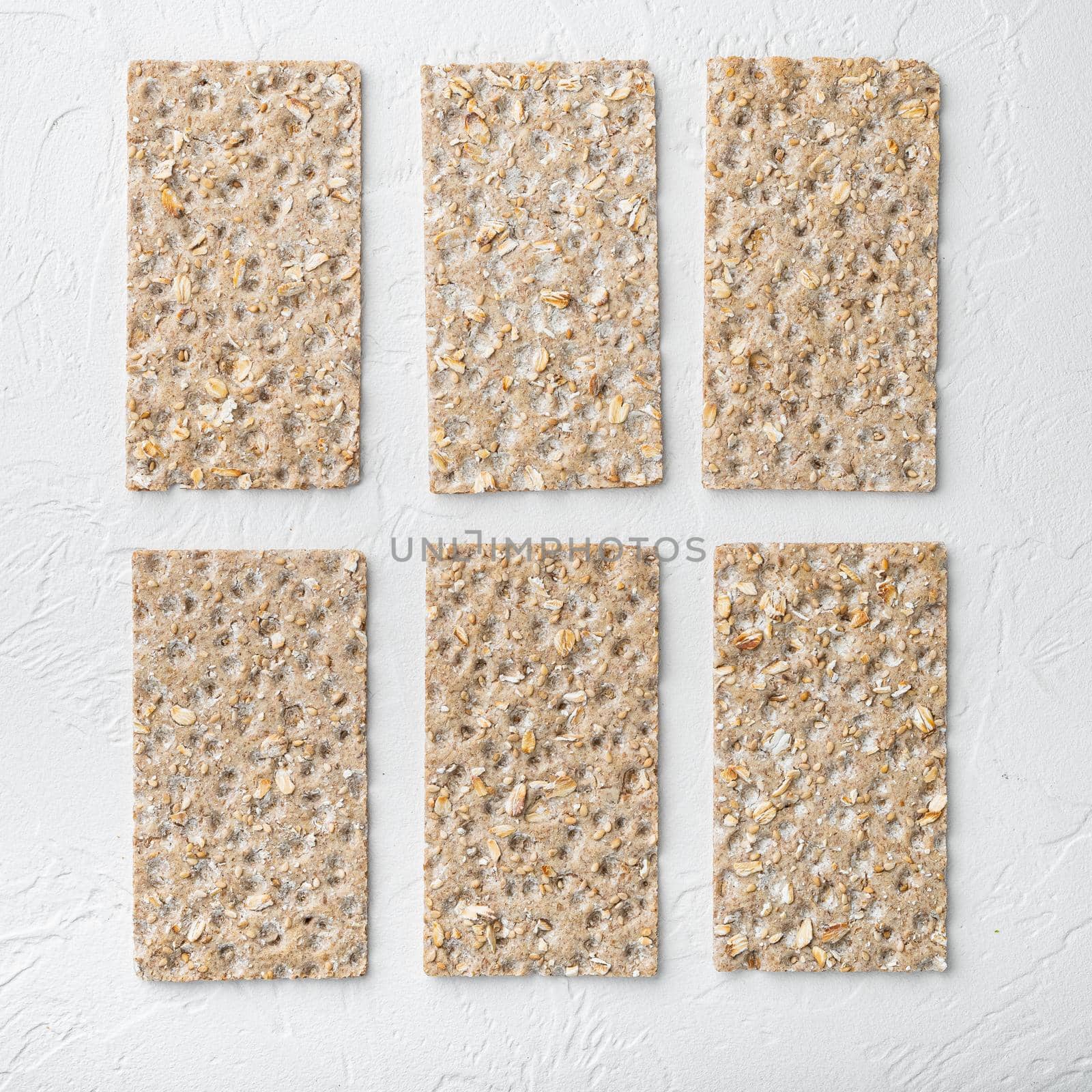 Grain diet light crisp bread set, square format, on white stone table background, top view flat lay, with copy space for text