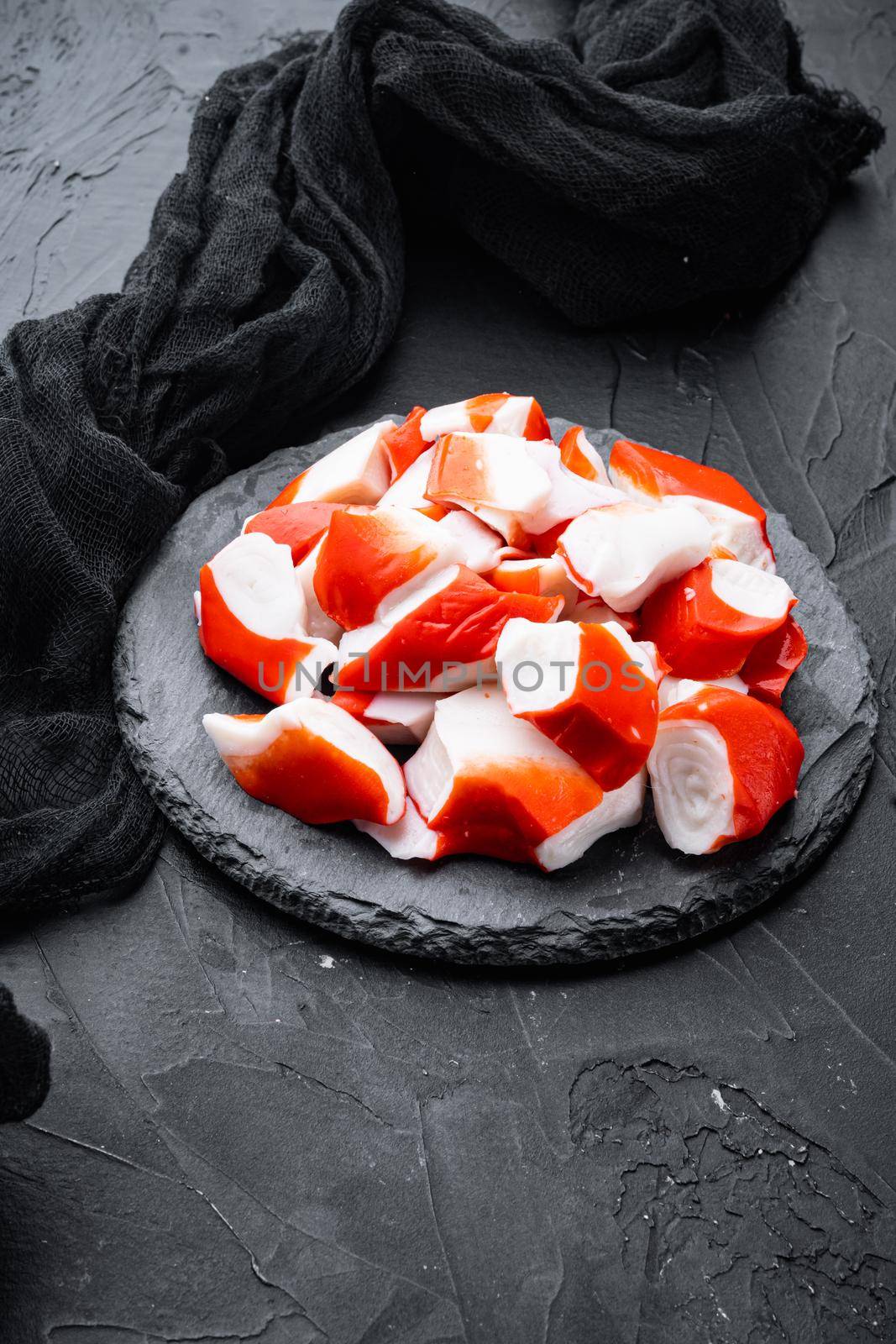 Fresh Crab meat surimi with blue swimming crab set, on stone board, on black background
