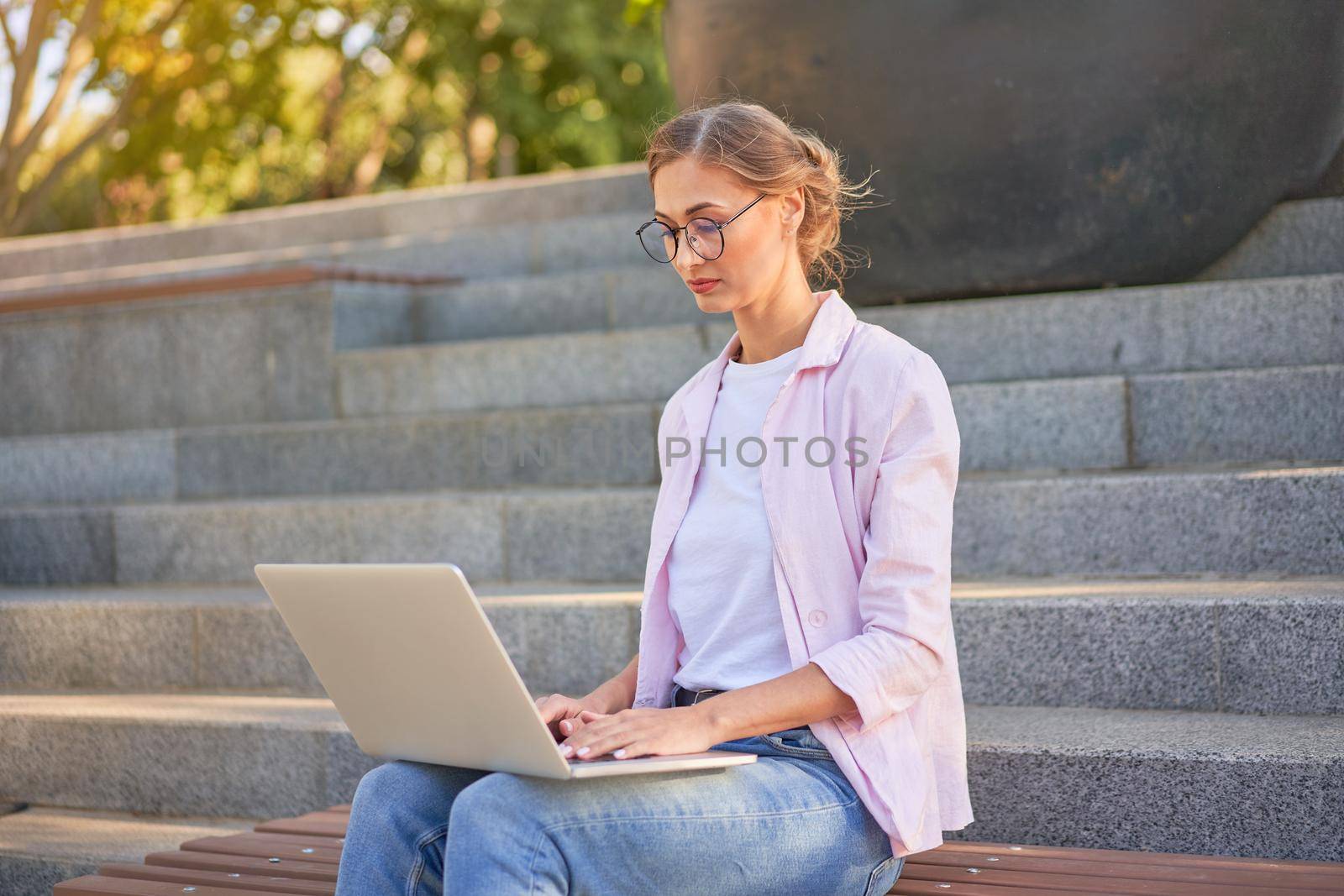 Businesswoman sitting stairs summer park using laptop Business persone working remote. Outdoor Successful european caucasian woman freelancer make video call teacher study work online lessons