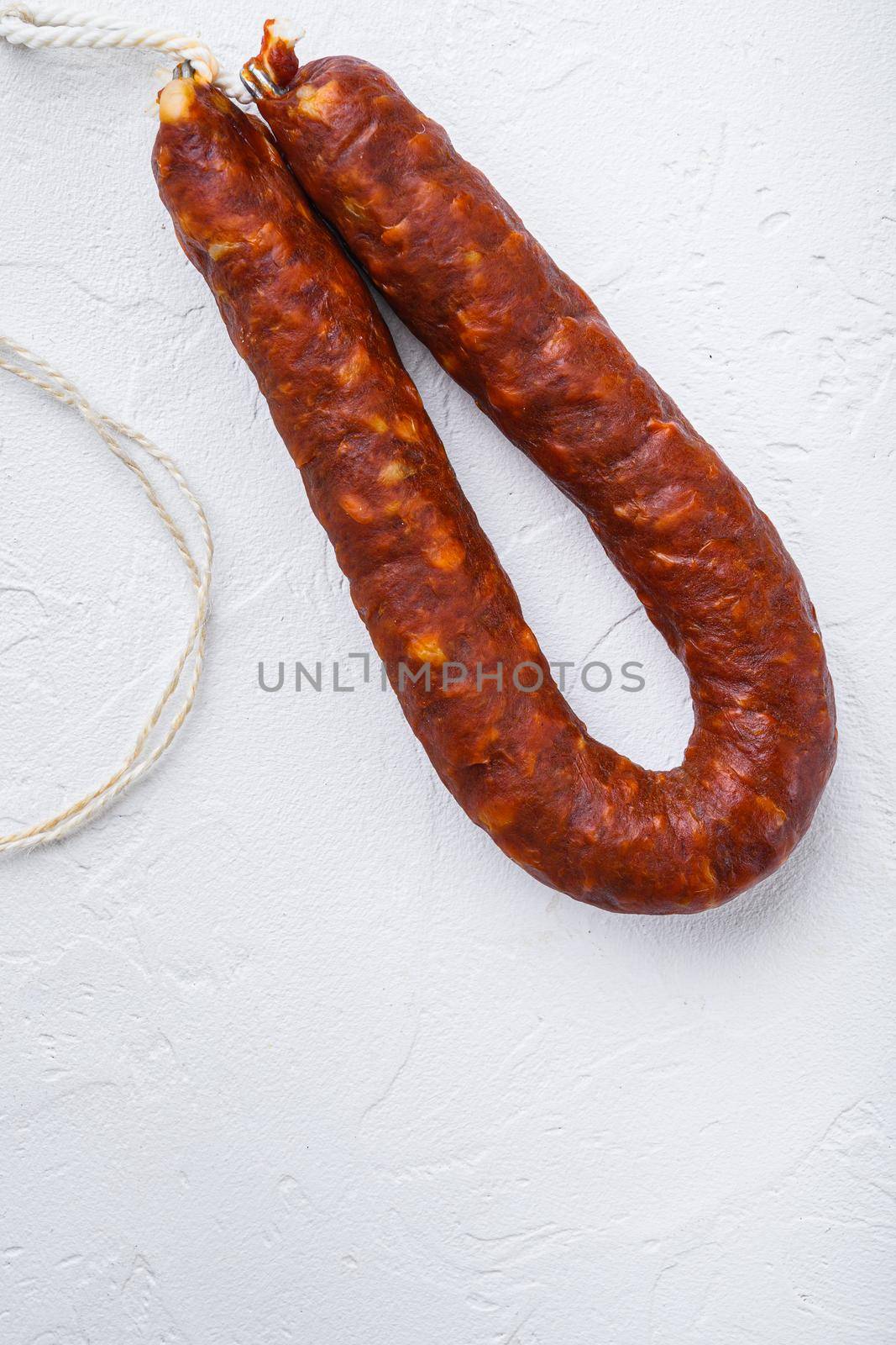 Spanish chorizo sausage on white background with space for text.