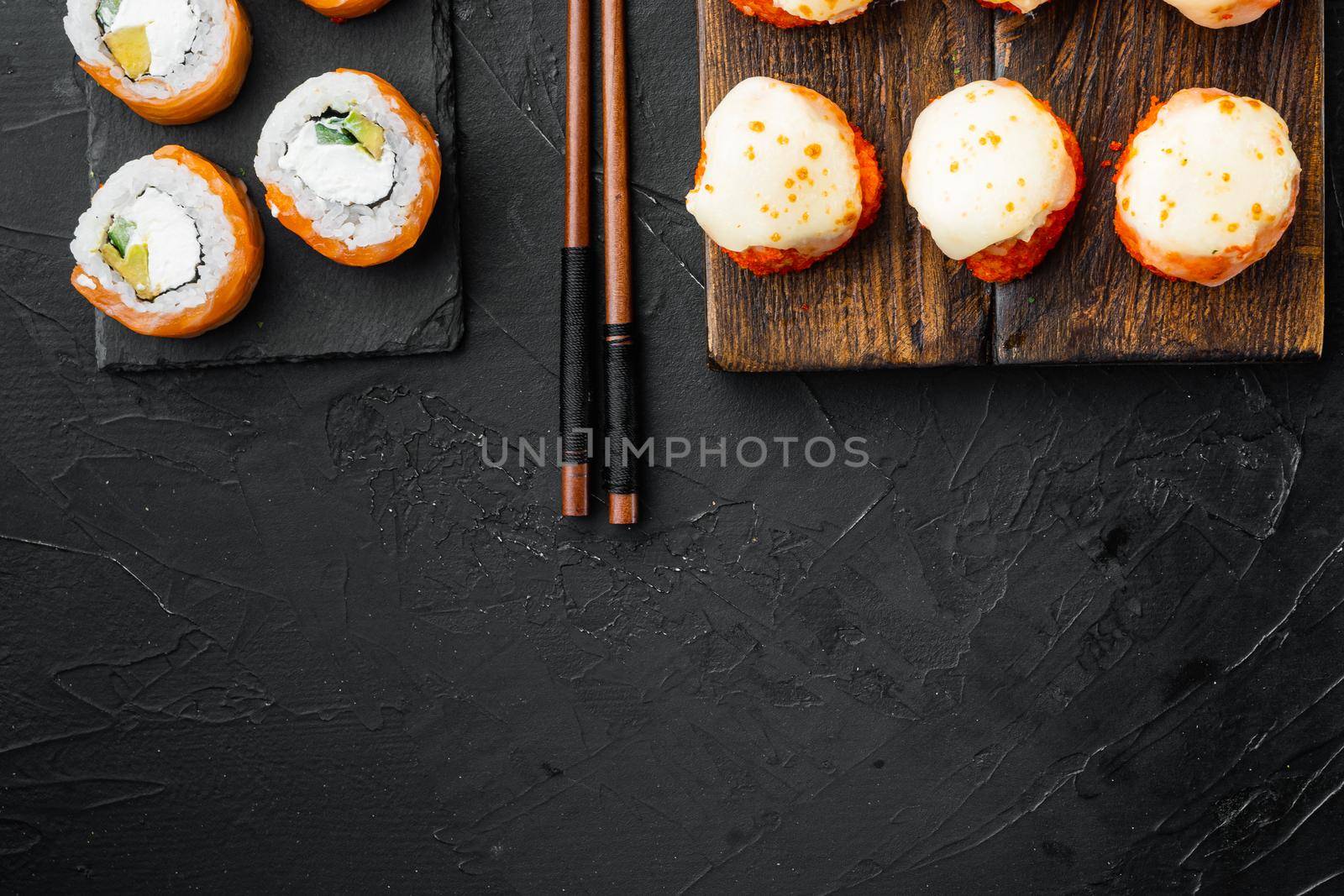 Sushi roll, Philadelphia with salmon, smoked eel, avocado, cream cheese set, on black stone background, top view flat lay , with copyspace and space for text