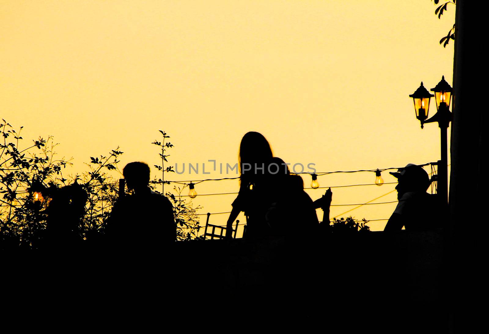 People enjoying and relaxing in a rooftop in Altea village at sunset in summer