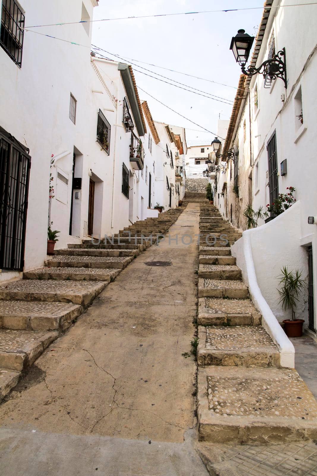 Narrow streets and beautiful whitewashed facades in Altea village, Alicante, Spain