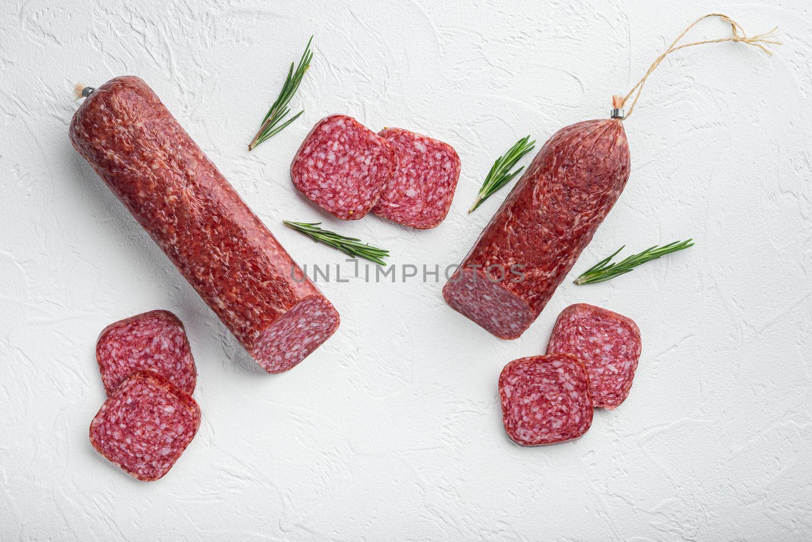 Salami with ingredients set, on white stone table background, top view flat lay