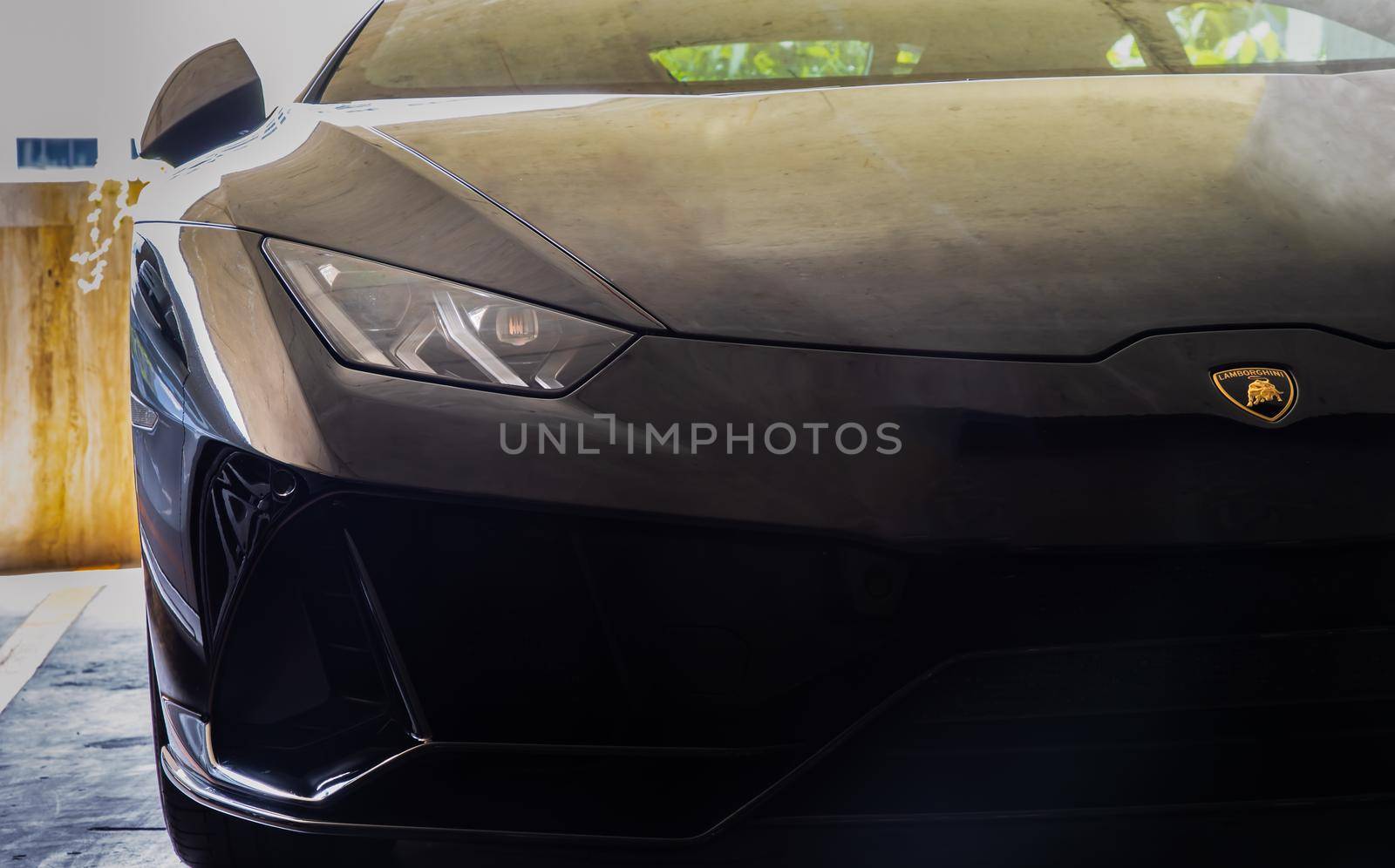 Bangkok, Thailand - 06 Jun 2021 : Close-up of Headlights of Black lamborghini sports car. Selective focus.