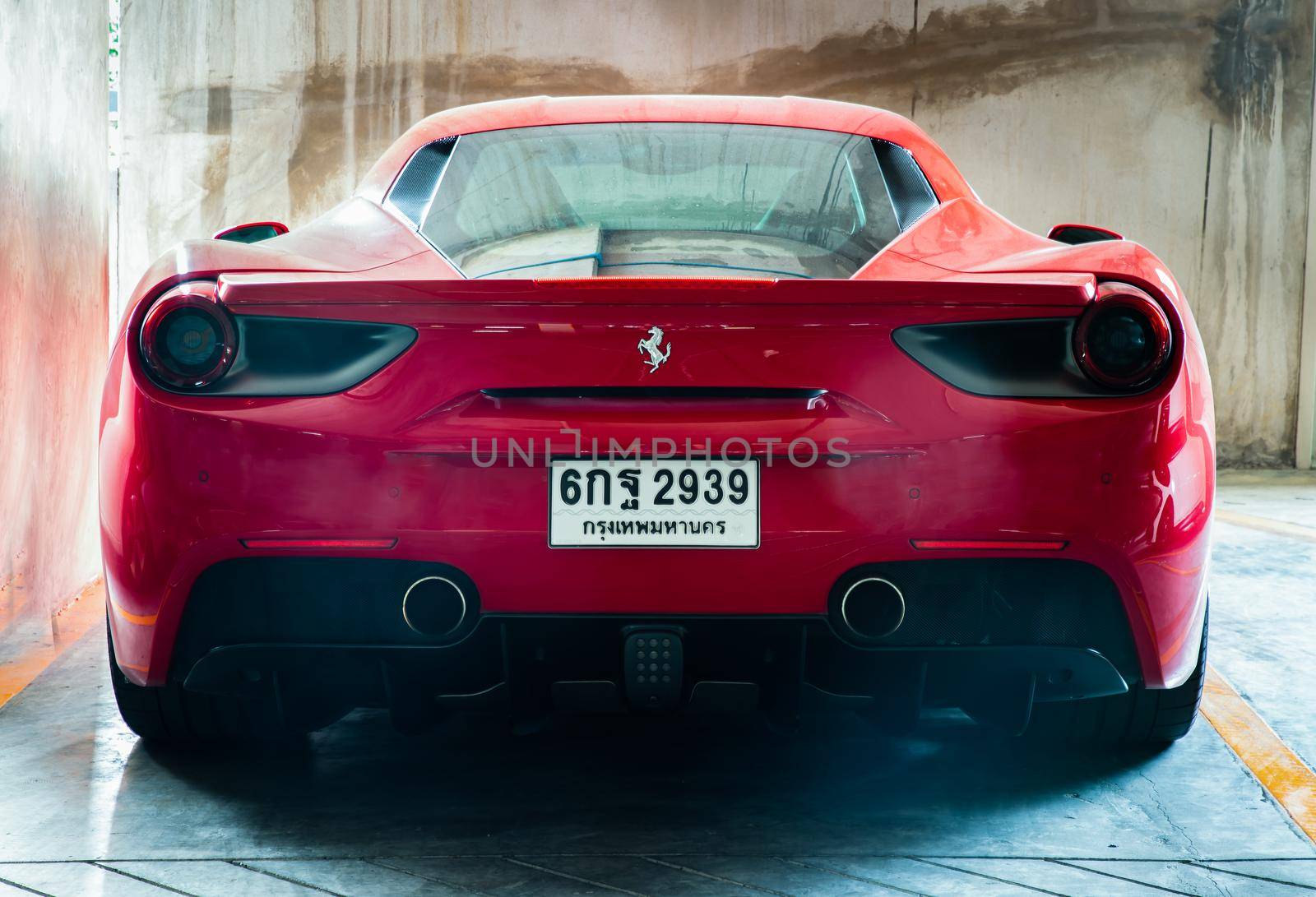Rear view of Red metallic Ferrari car. Ferrari is Italian sports car.  by tosirikul