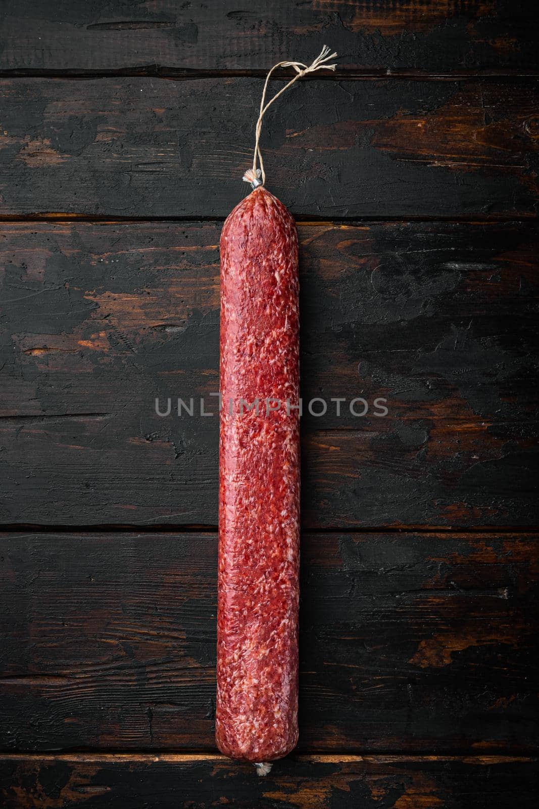 Salami sausage set, on old dark wooden table background, top view flat lay, with copy space for text