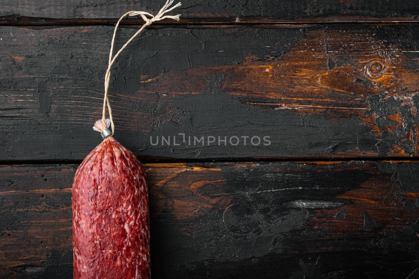 Sausage salami cured set, on old dark wooden table background, top view flat lay, with copy space for text