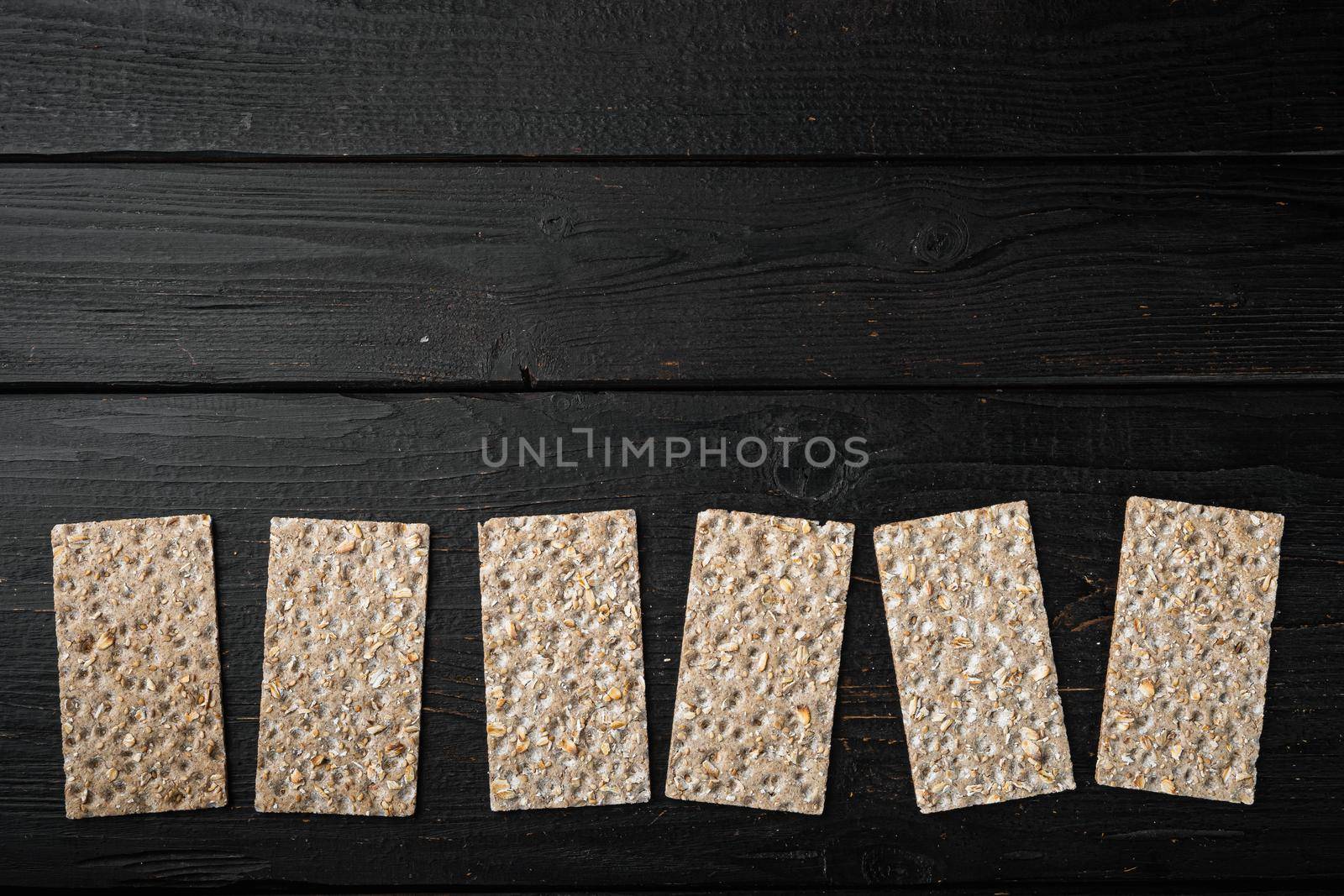 Buckwheat crisp bread set, on black wooden table background, top view flat lay, with copy space for text
