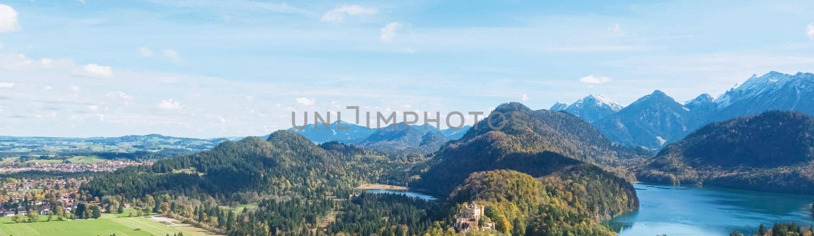Beautiful nature of European Alps, landscape view of alpine mountains, lake and village on a sunny day, travel and destination by Anneleven