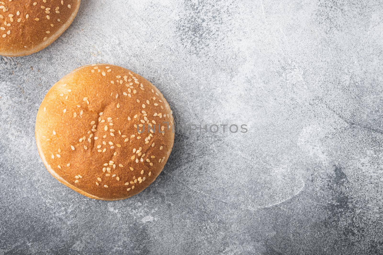 Hamburger buns with sesame set, on gray background, top view flat lay, with copy space for text