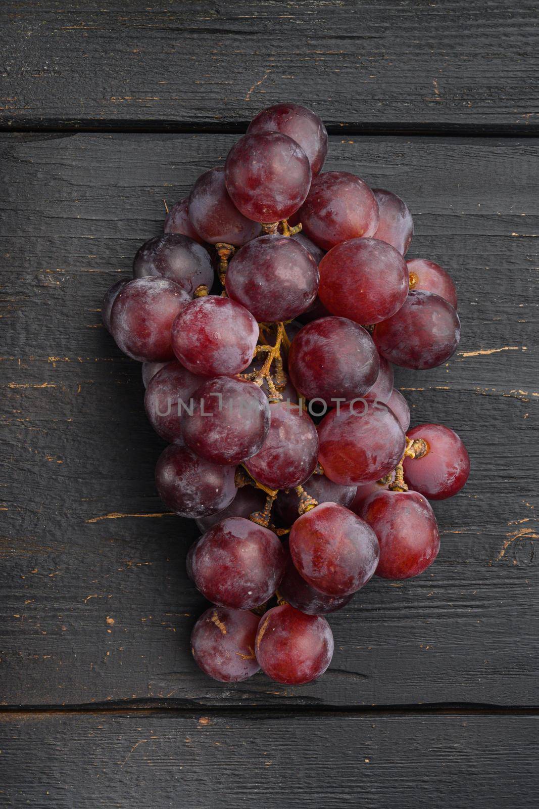 Natural organic juicy grapes set, dark red fruits, on black wooden table, top view flat lay