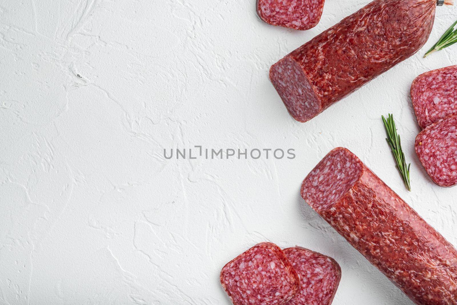 Salami with fresh rosemary and spices set, on white stone table background, top view flat lay, with copy space for text