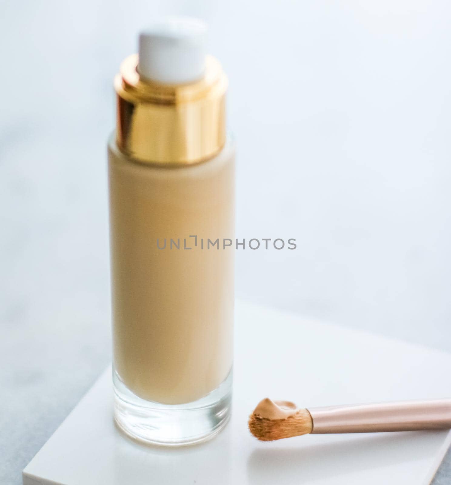 Cosmetic branding, glamour and skincare concept - Makeup foundation bottle and contouring brush on marble, make-up concealer bb cream as cosmetics product for luxury beauty brand holiday design