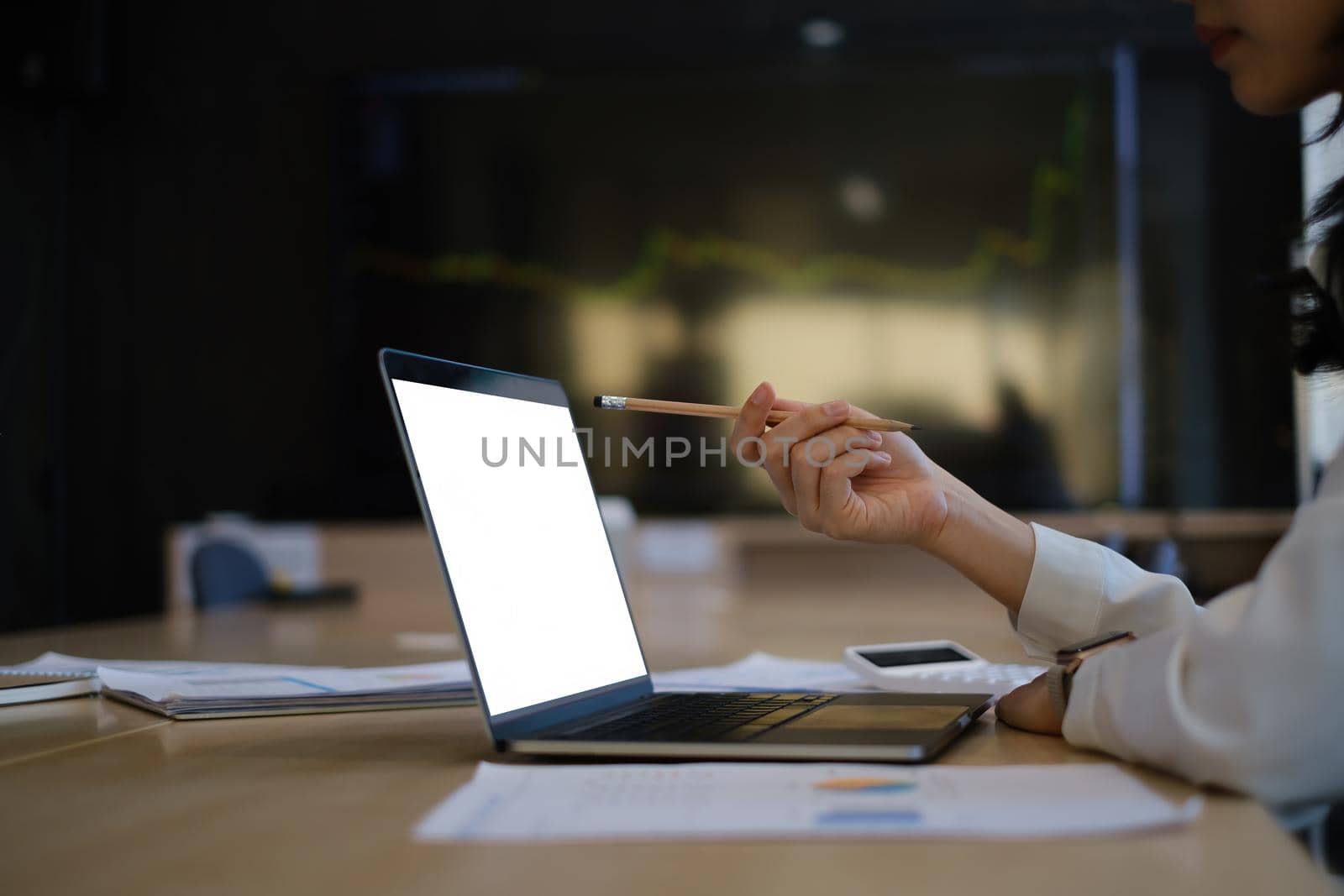 Business woman trader investor using laptop with cryptocurrency stock market graph on background. stock chart, investment concept. by itchaznong