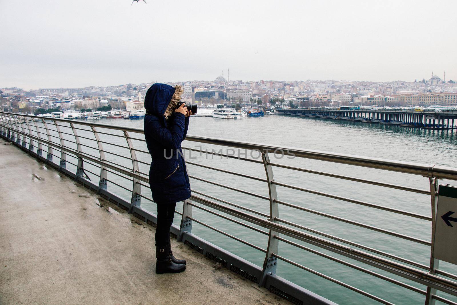 tourist girl photographer with dslr camera outdoor on the bridge by berkay