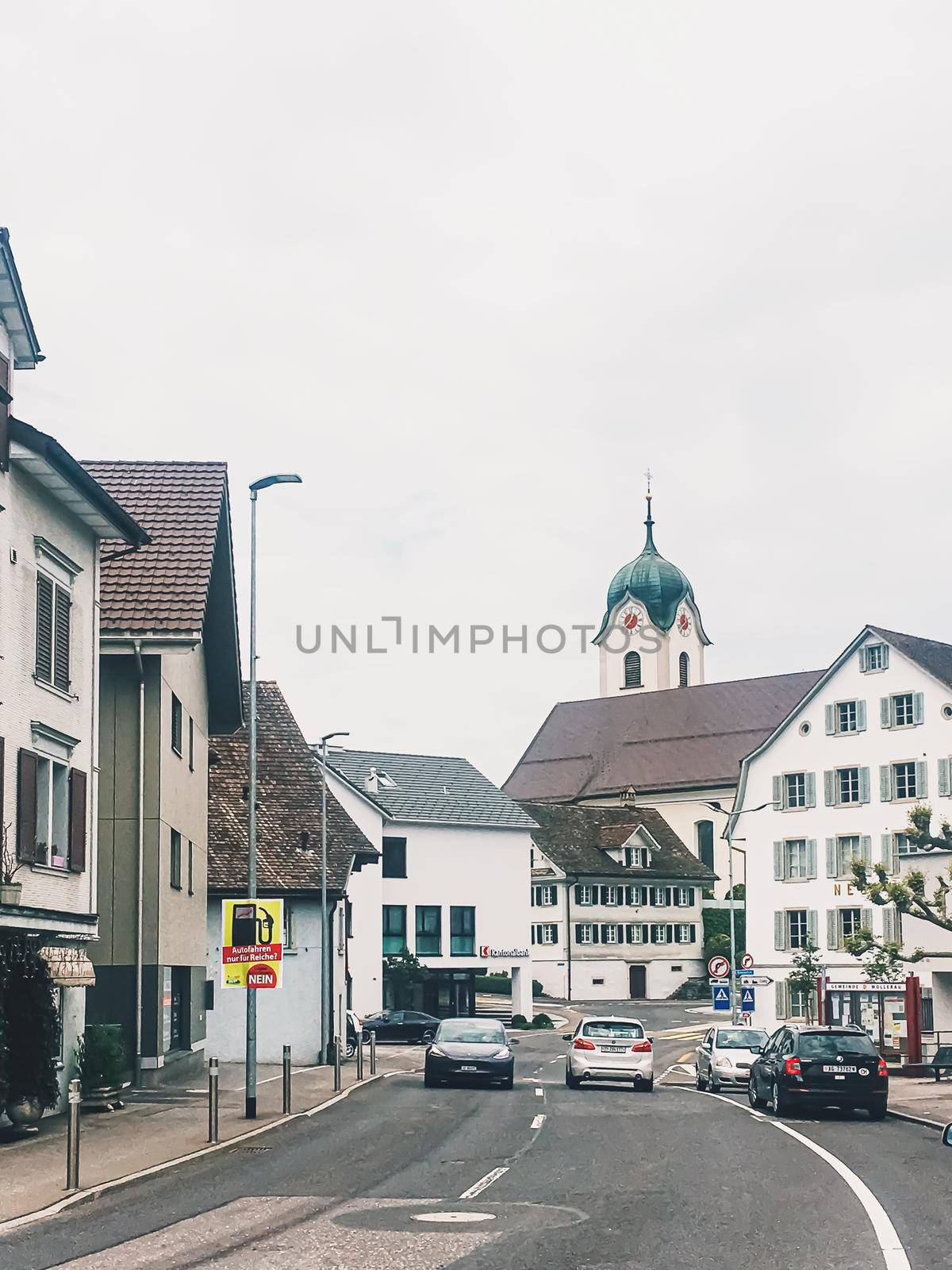 Historic buildings, church and houses on street of Wollerau, canton of Schwyz in Switzerland, Swiss architecture and real estate by Anneleven