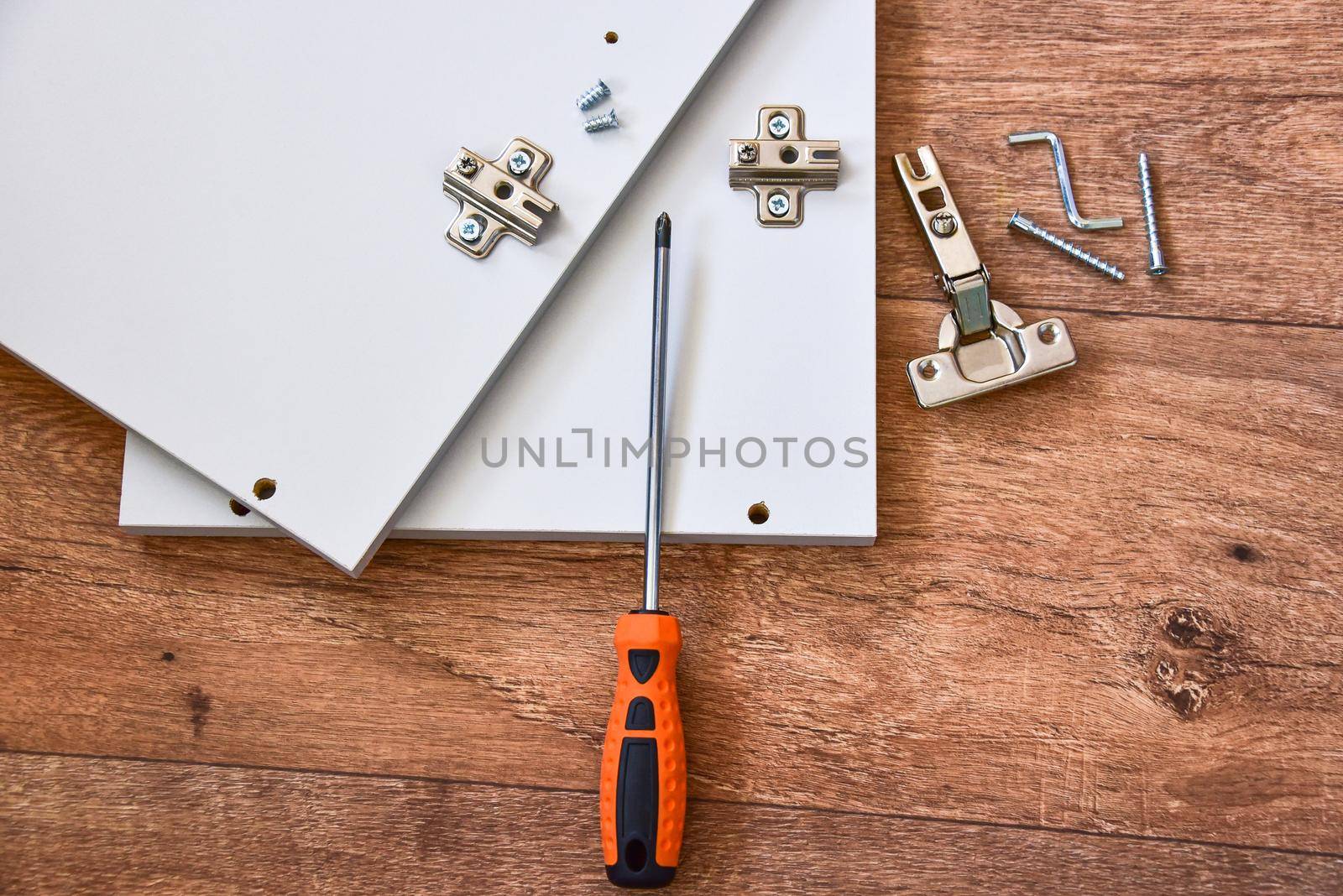 Assembly of cabinet furniture. screwdriver, screws, furniture fittings, door hinges. self-assembly of furniture.