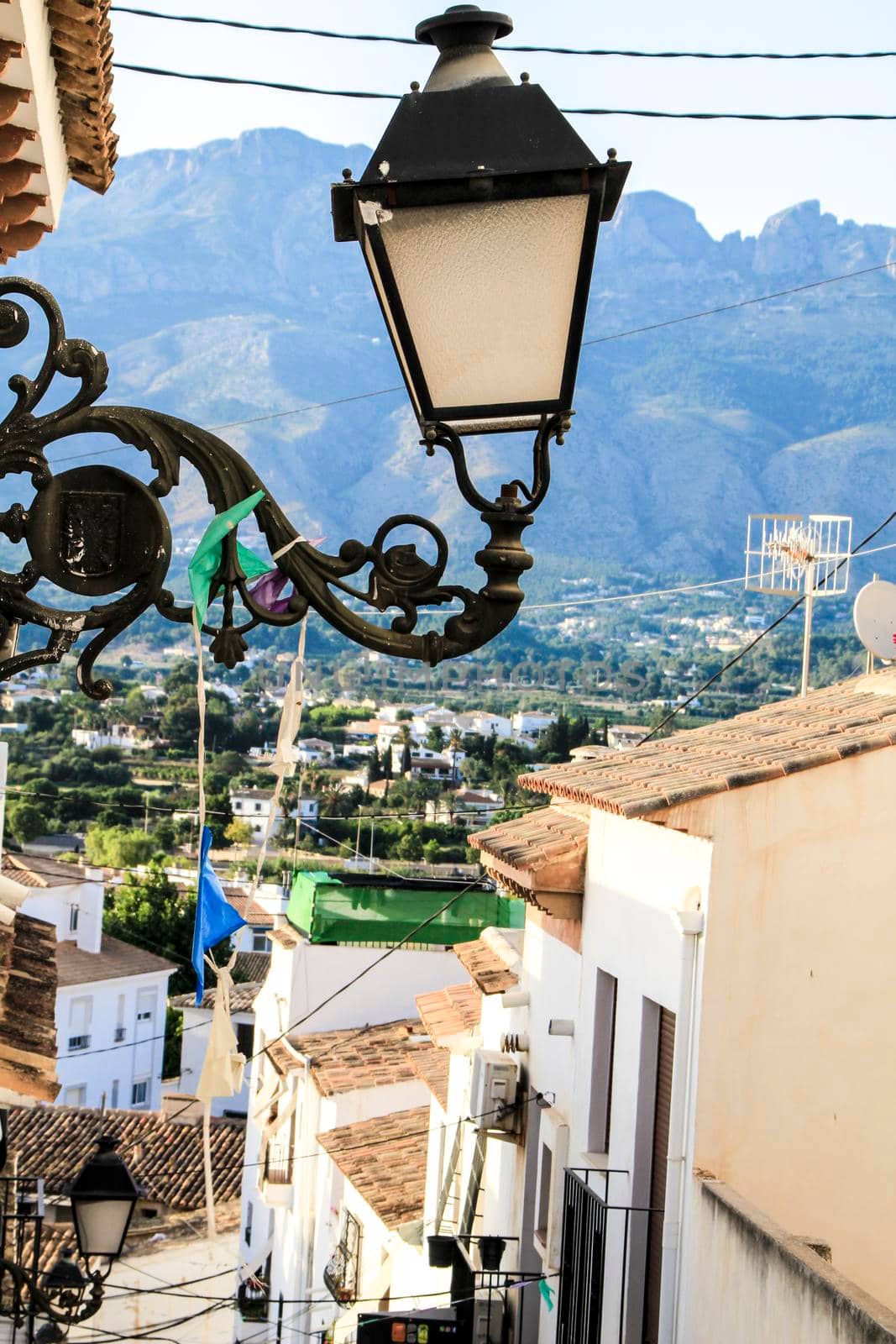 Narrow streets and beautiful whitewashed facades with vintage streetlight in Altea village, Alicante, Spain
