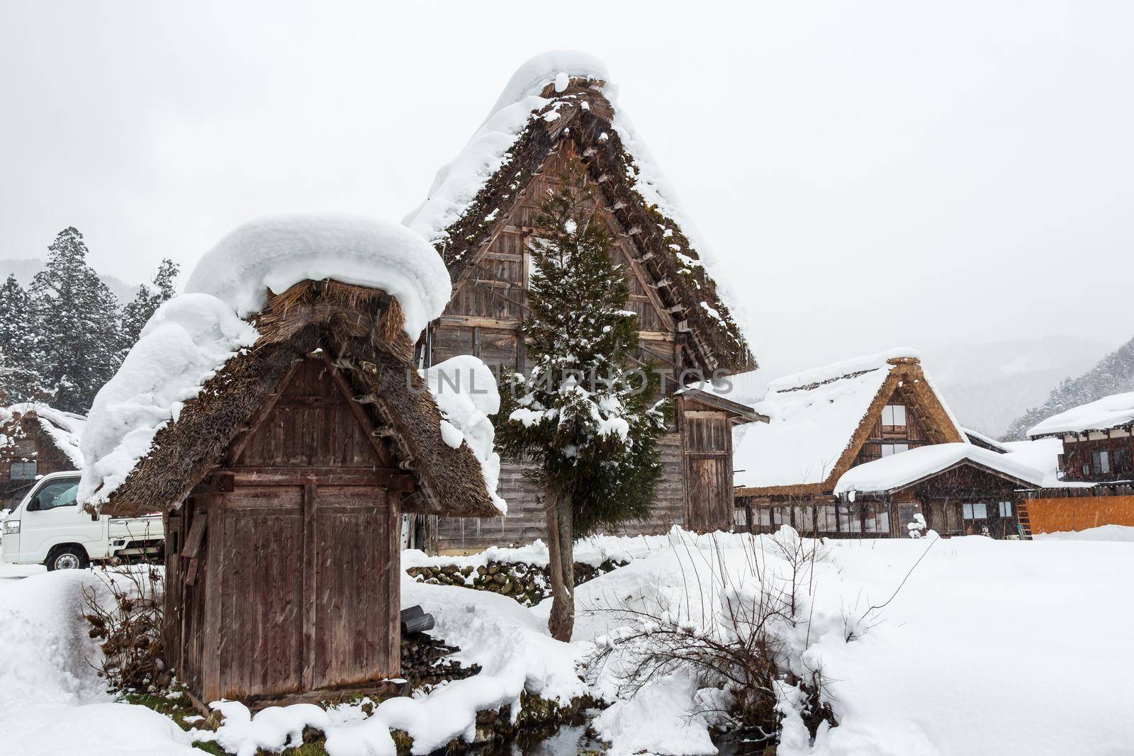 Shirakawago village with snow fall in winter season . Landmark of Gifu , Takayama , Japan . by stockdevil
