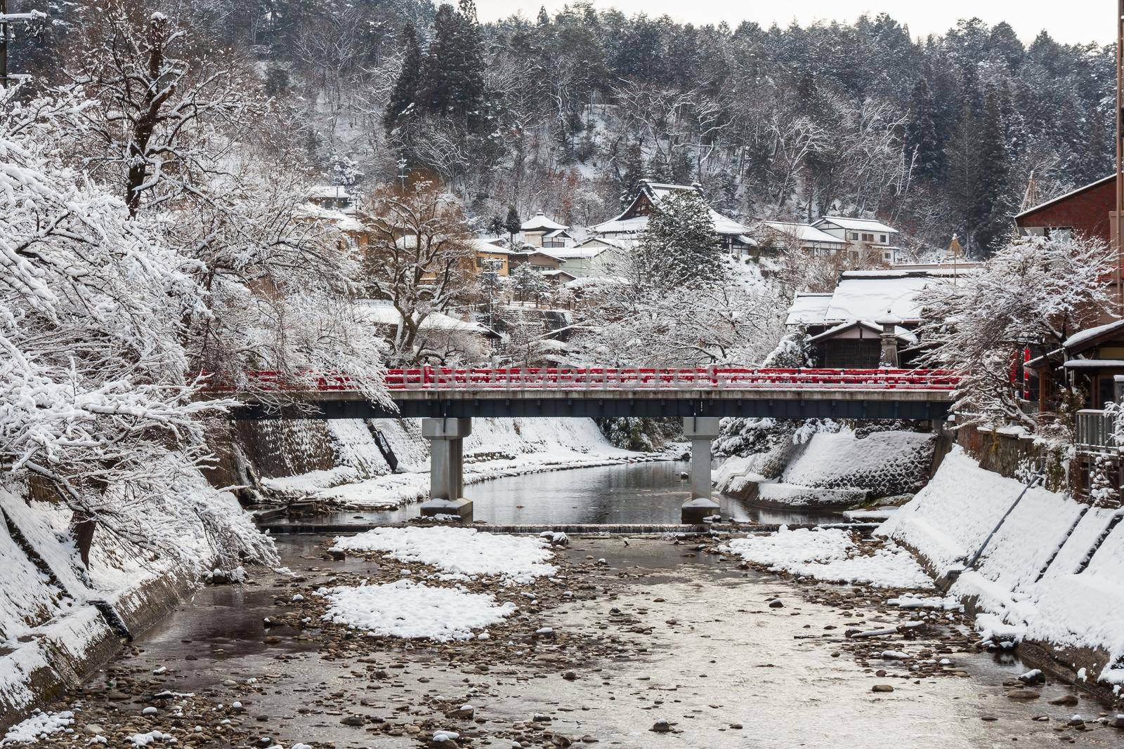 Nakabashi Bridge with snow fall and Miyakawa river in winter season . Landmark of Hida - Gifu - Takayama , Japan . Landscape view . by stockdevil