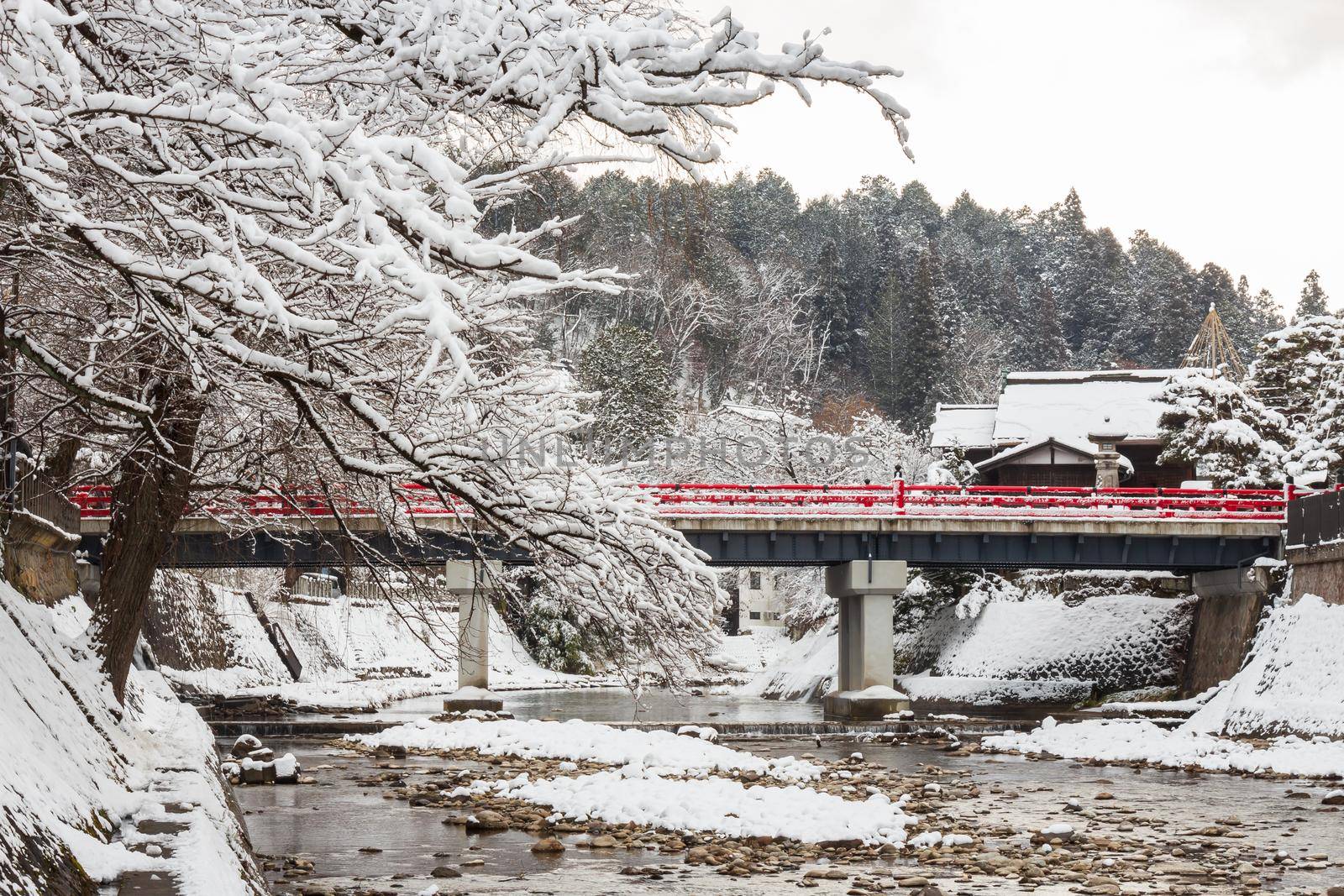 Nakabashi Bridge with snow fall and Miyakawa river in winter season . Landmark of Hida , Gifu , Takayama , Japan . Landscape view . by stockdevil