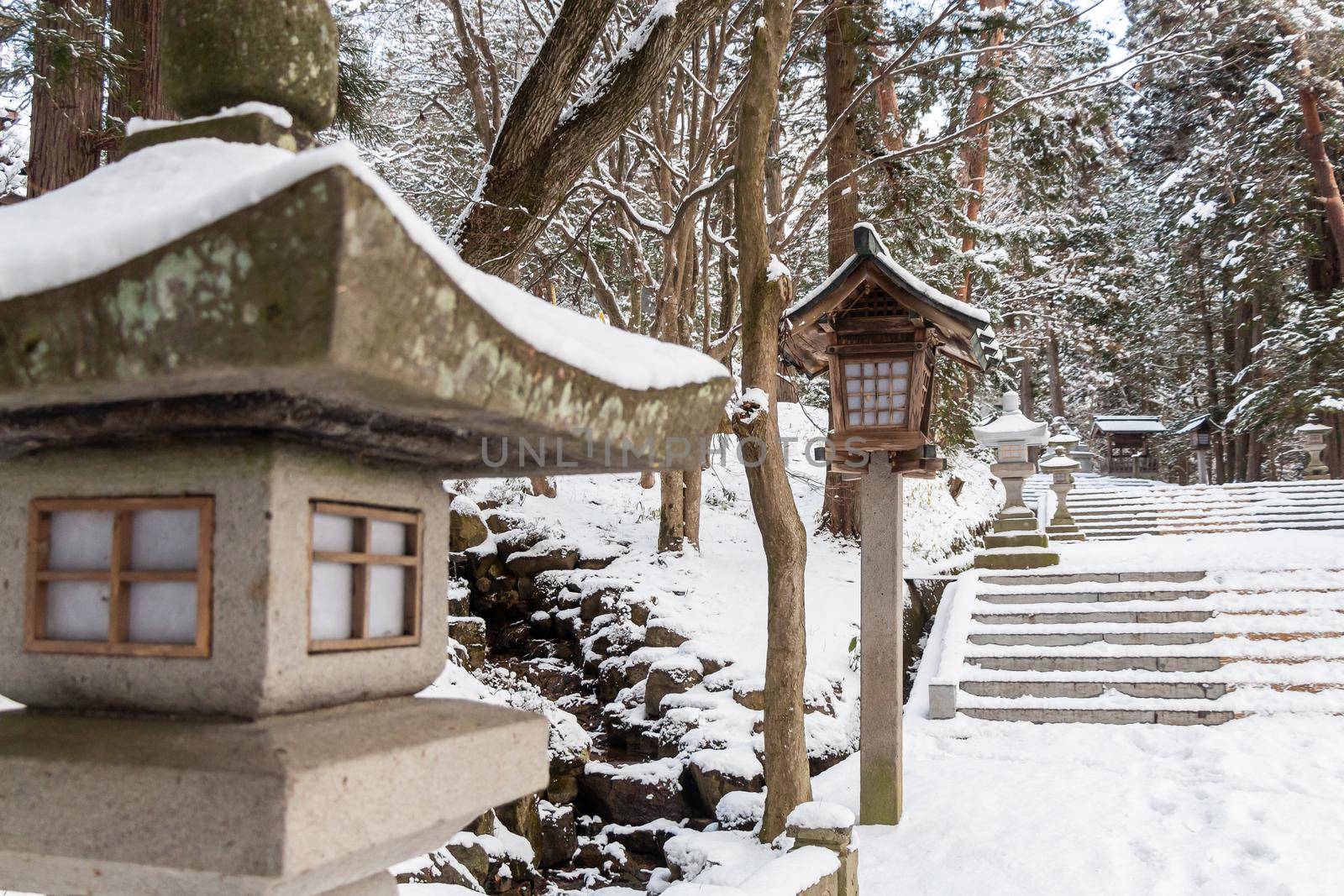 Japanese stone and wooden lantern with snow at Hida-sannogu Hie-Jinja shrine in winter season . At Gifu , Hida Takayama , Japan . by stockdevil
