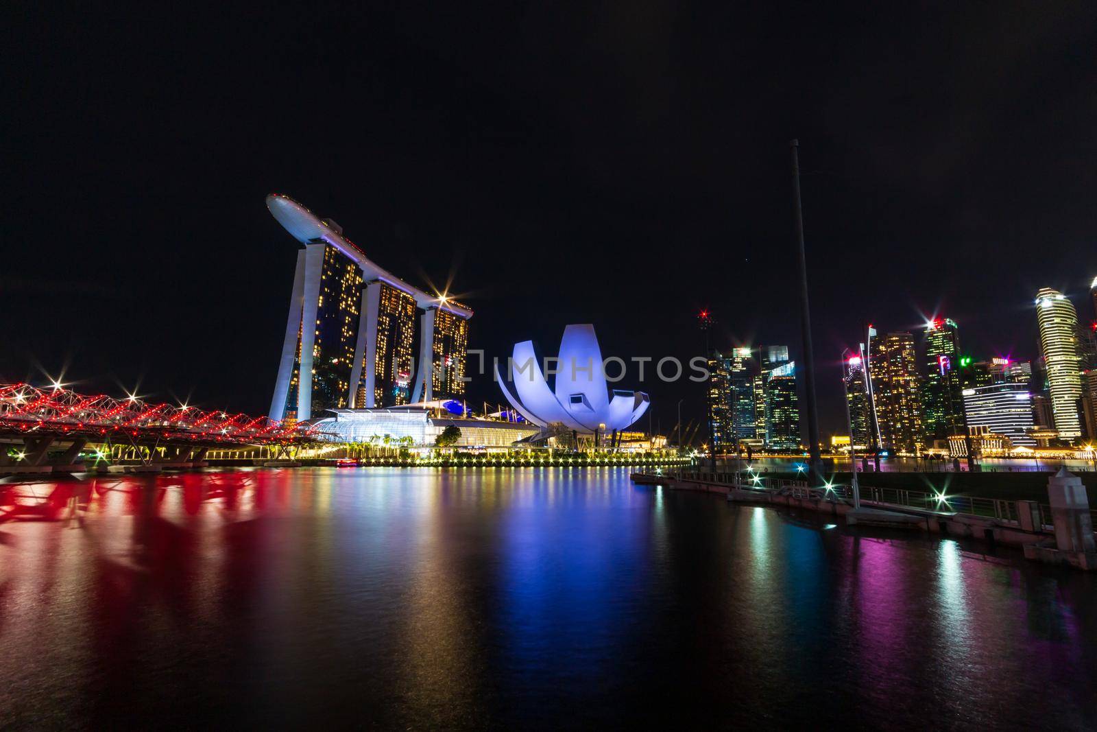 Singapore skyline cityscape around marina bay at night .