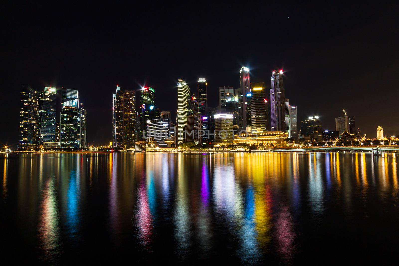 Singapore skyline cityscape and building around marina bay at night by stockdevil