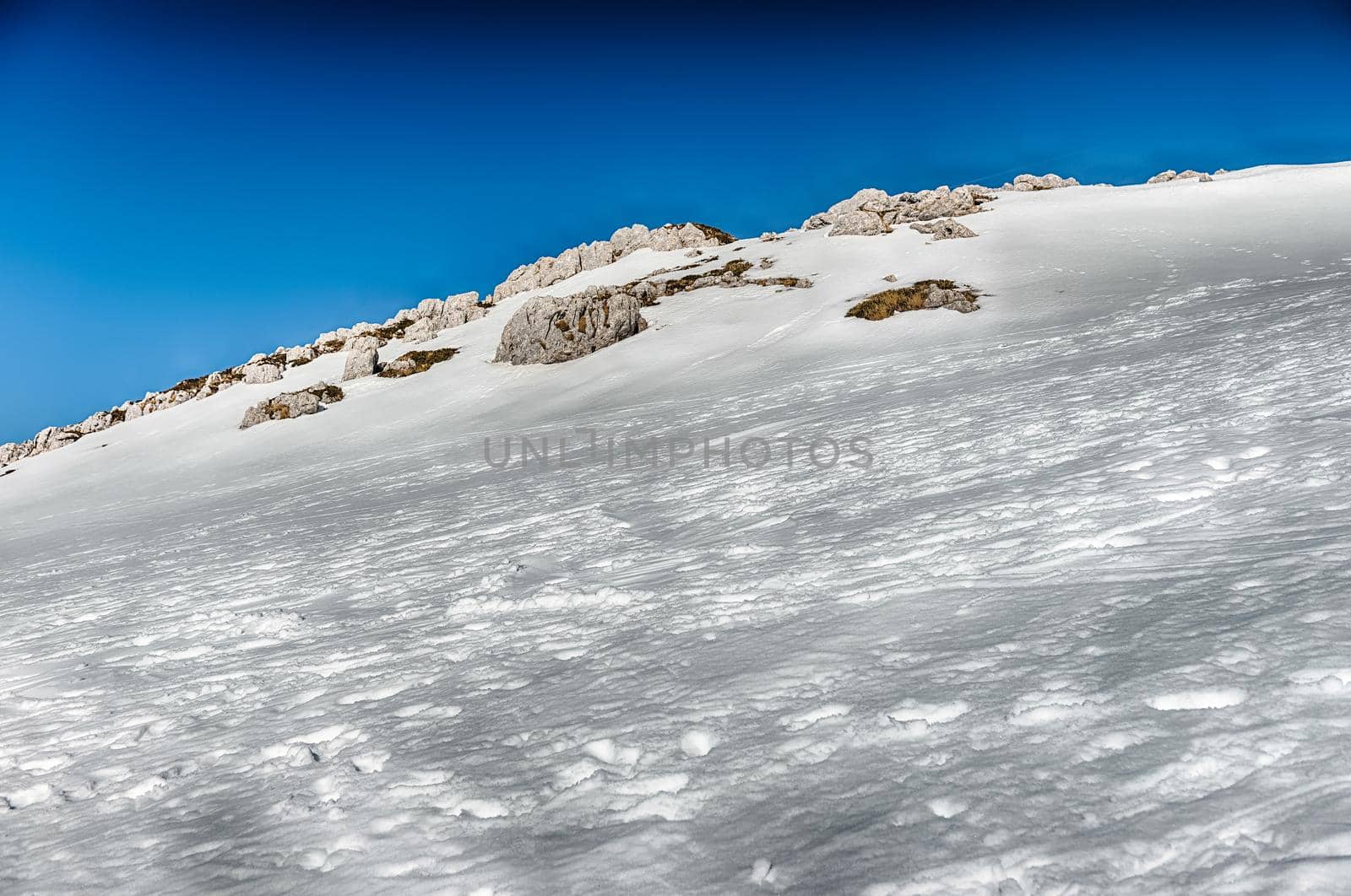 Scenic winter landscape with snow covered mountains, Campocatino, Italy by marcorubino