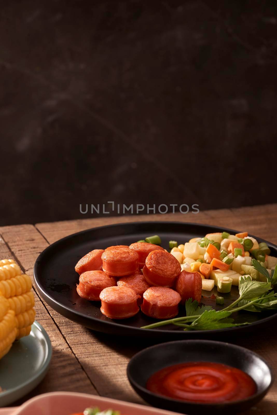 Grilled sausages with sauce ketchup on a wooden table