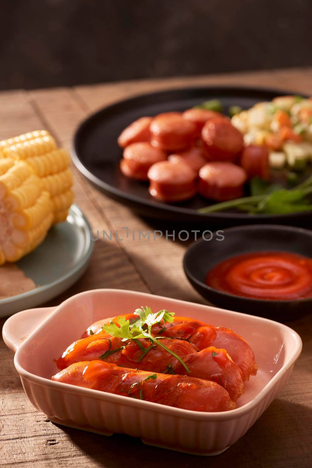 Grilled sausages with sauce ketchup on a wooden table